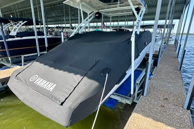 2021 Yamaha Boats 275SD covered in a dock, showcasing sleek design and protection.