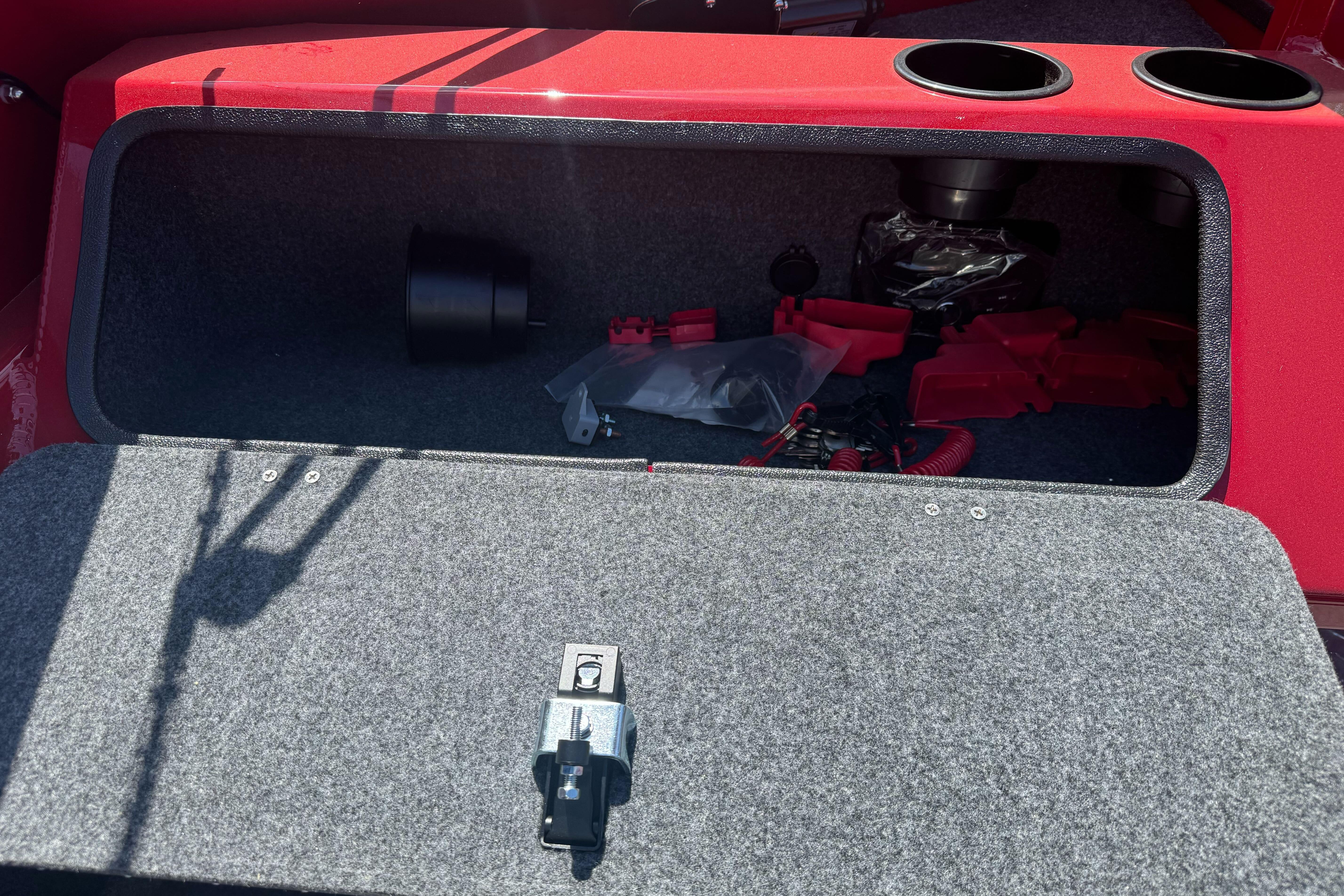 Open storage compartment in 2026 Lund 210 Heavy Gauge boat, showing interior and accessories.