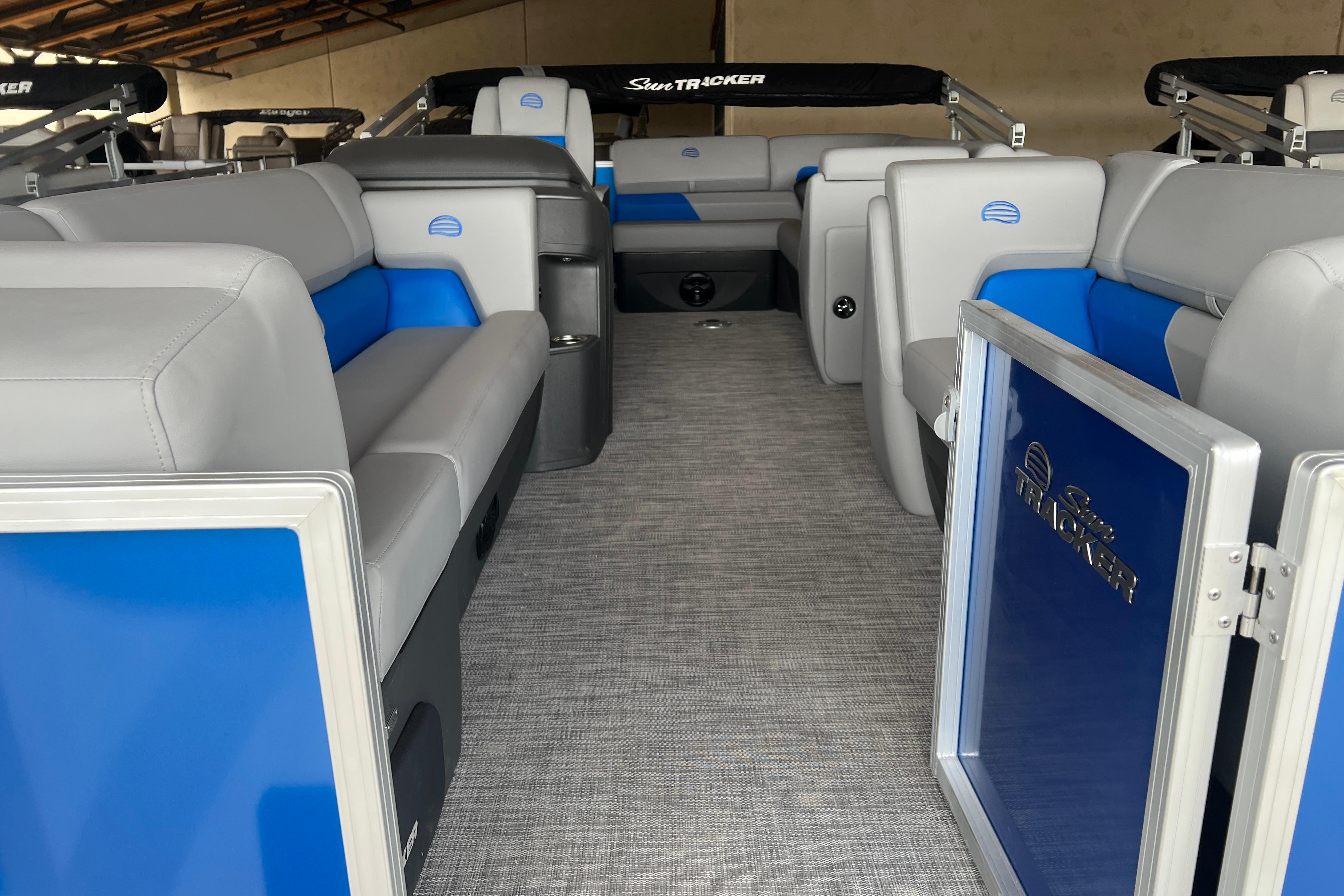 Interior of 2026 Sun Tracker Party Barge 20 DLX with gray and blue seating.