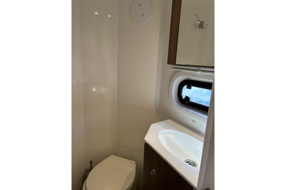 Compact bathroom in 2023 Bali 4.2 model with sink, toilet, and window.