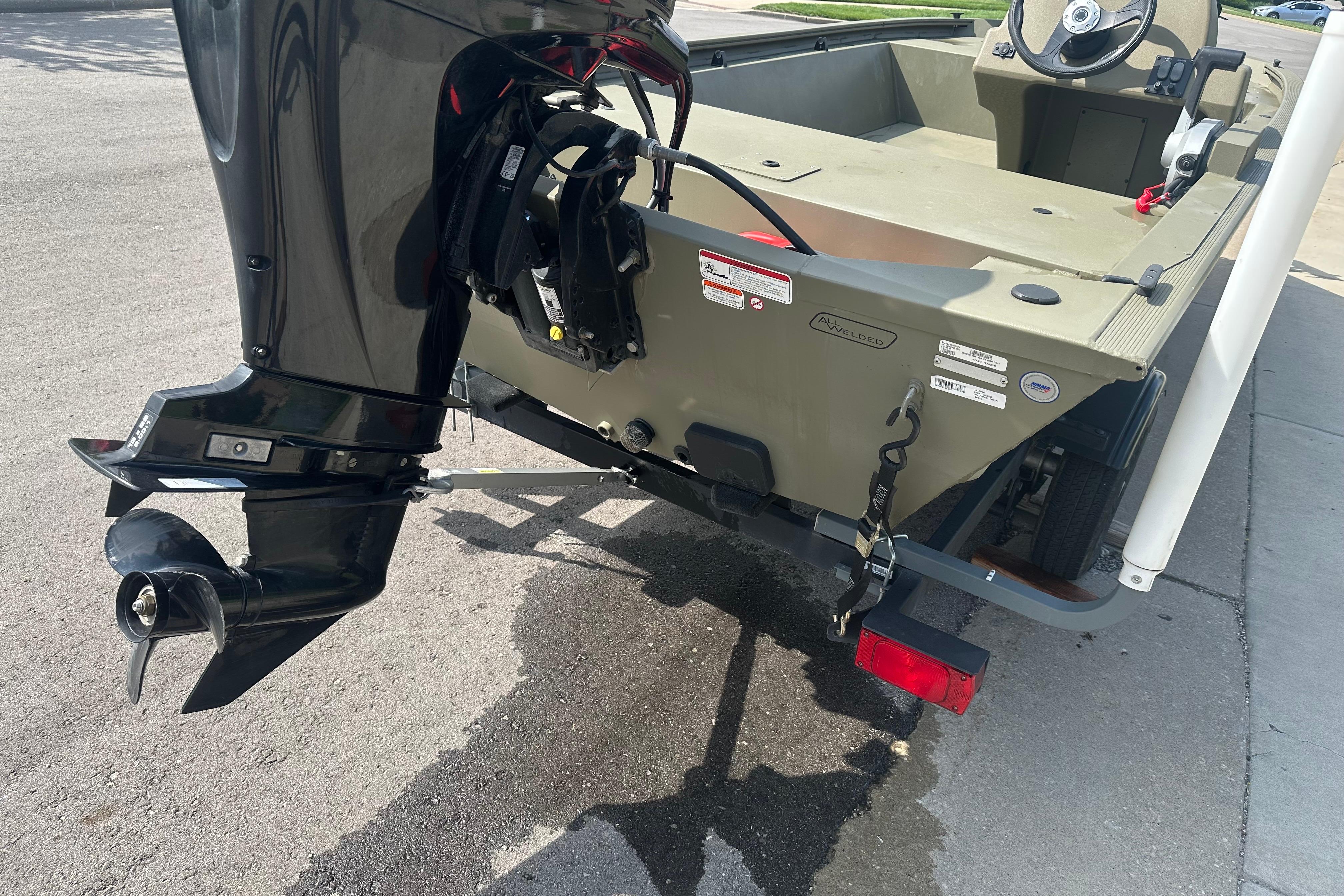 2024 Tracker Grizzly 1648 SC boat with outboard motor on a trailer.