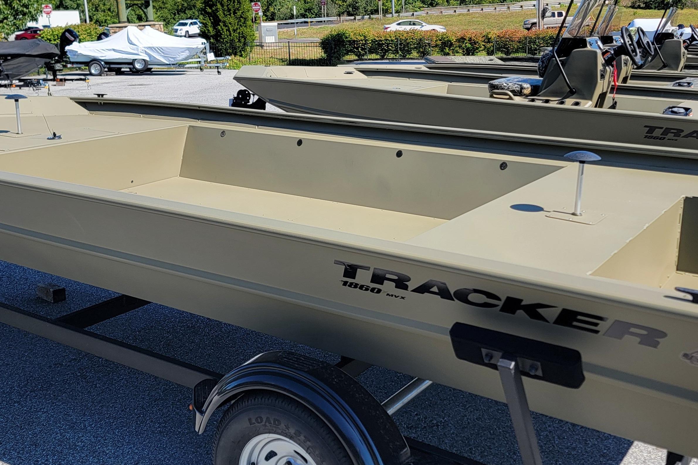 2026 Tracker Grizzly 1860 Utility boat on trailer in outdoor showroom.