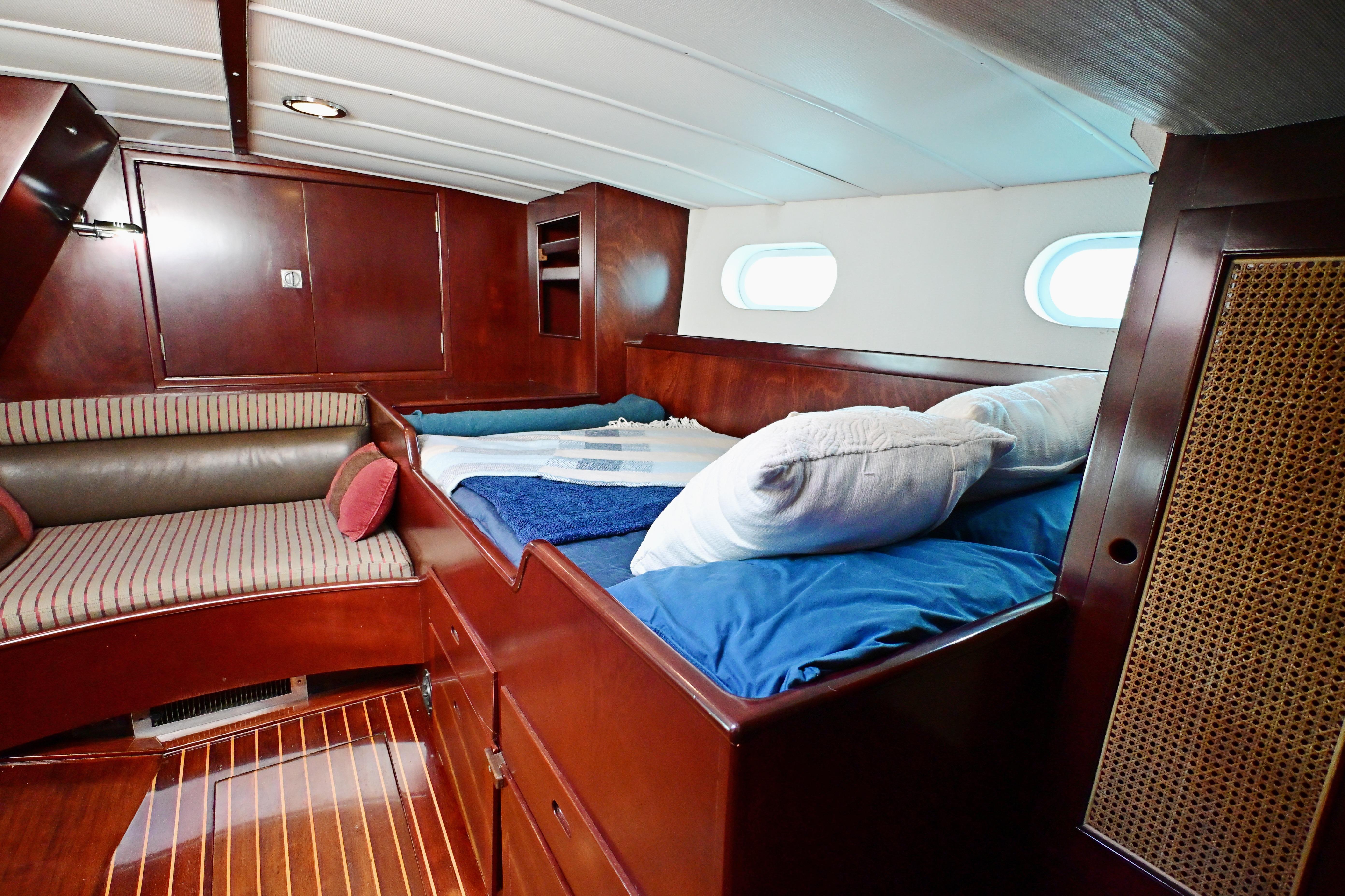Luxurious cabin interior of 1968 Abeking & Rasmussen Tripp 74 yacht with wooden finishes.