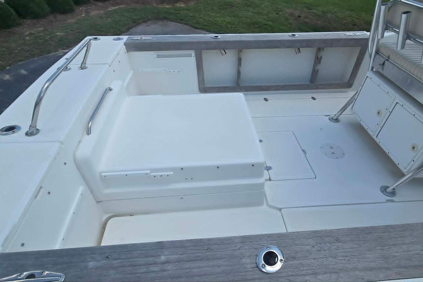 2003 True World Marine 286 boat deck with seating and storage compartments.