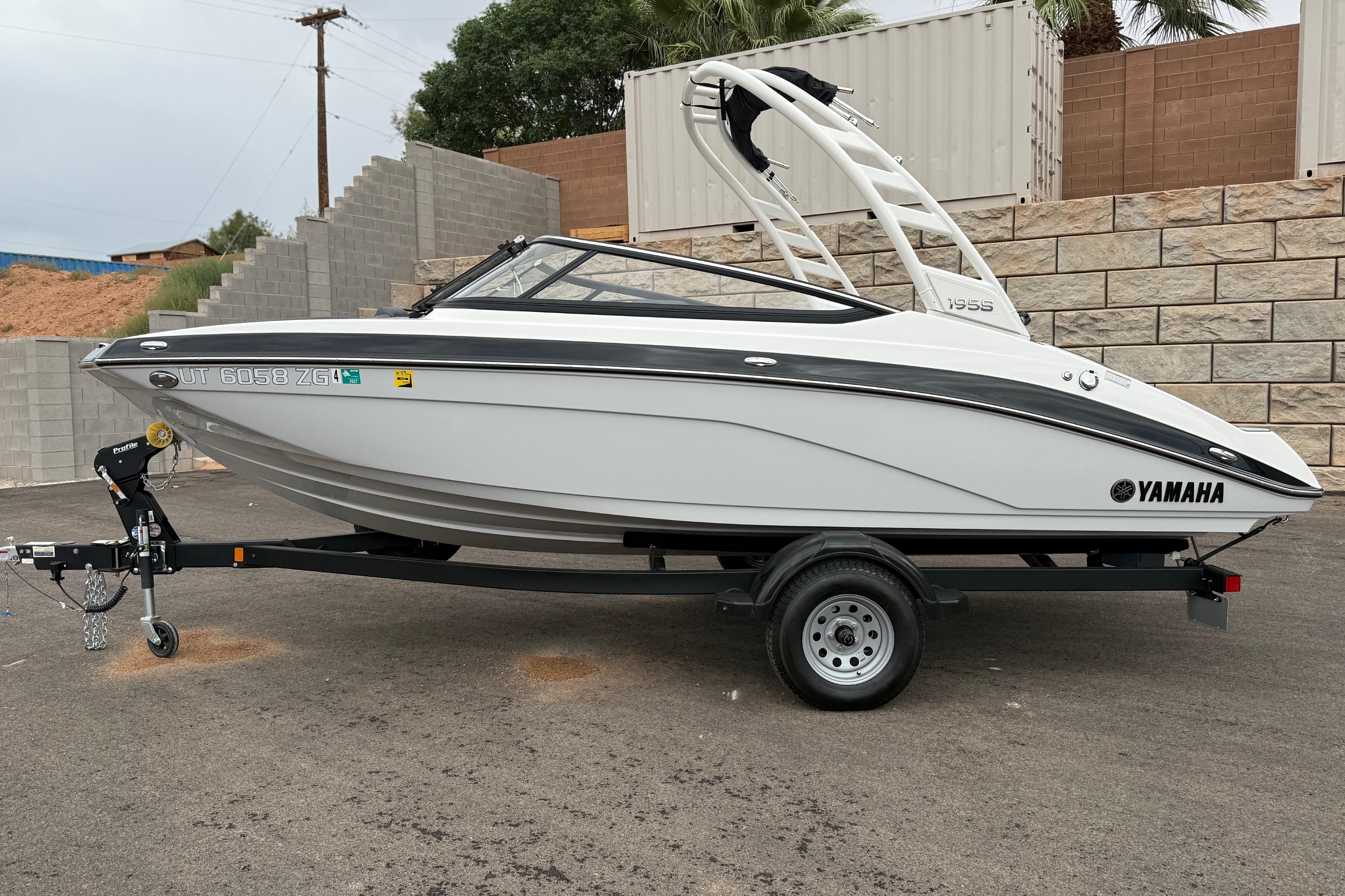 2025 Yamaha Boats 195S on trailer, sleek white design, parked outdoors.