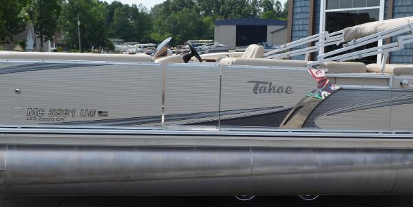 2018 Tahoe LTZ 2285 CR pontoon boat docked near a building.