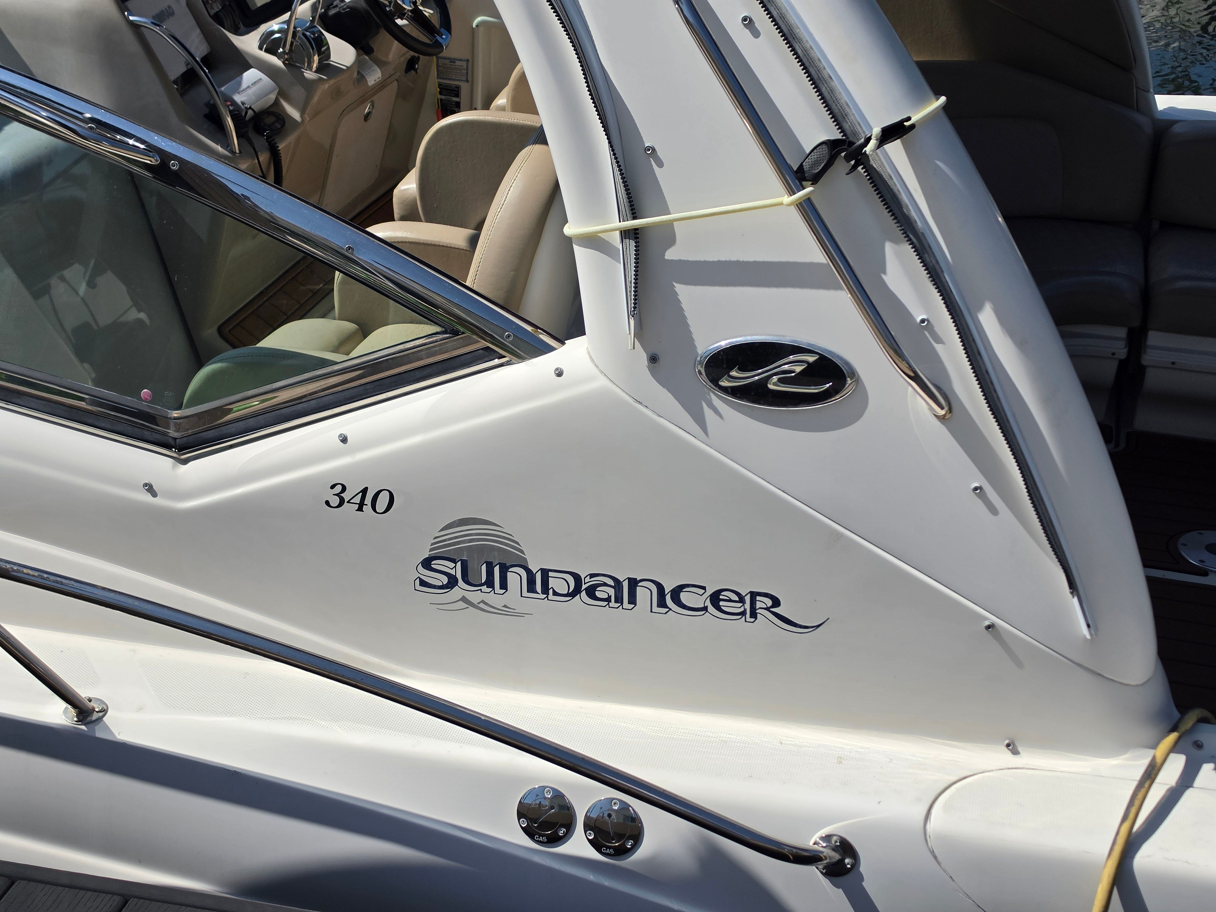 Close-up of a white 2004 Sea Ray 340 Sundancer boat with logo and lettering.