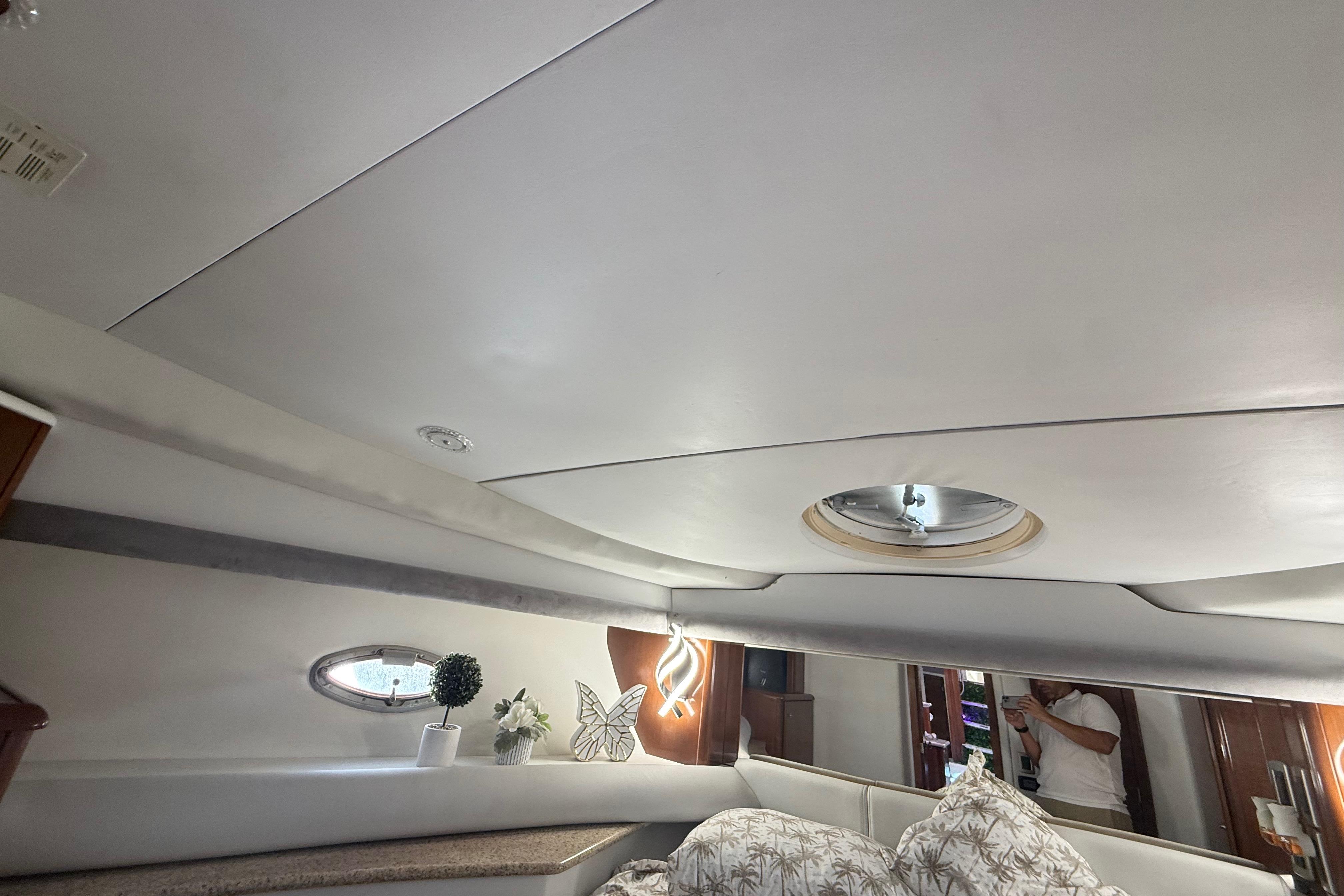 Interior of 2007 Meridian 459 Motoryacht cabin with modern decor and porthole window.