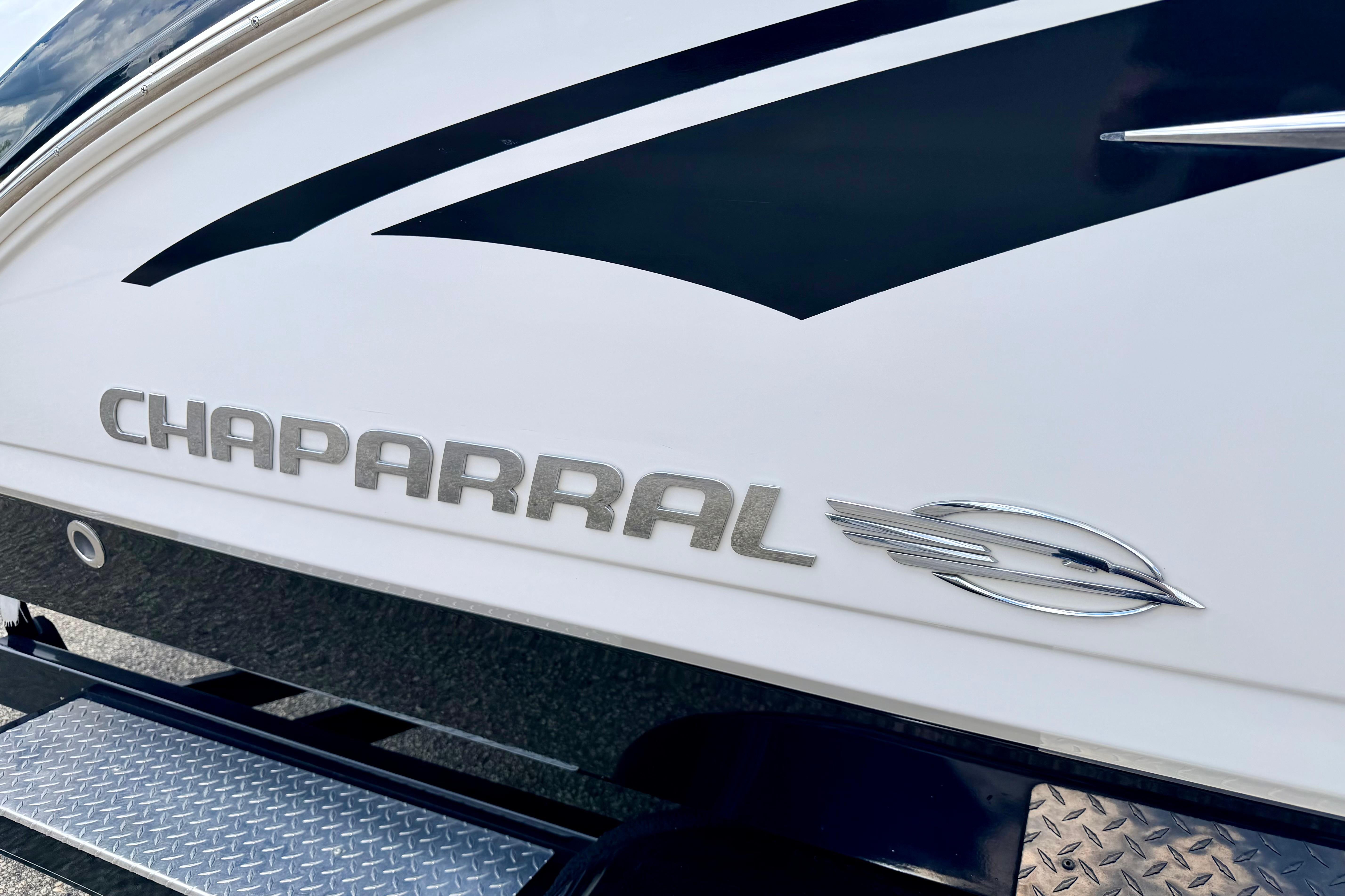2015 Chaparral Sunesta 264 boat logo on sleek white hull.