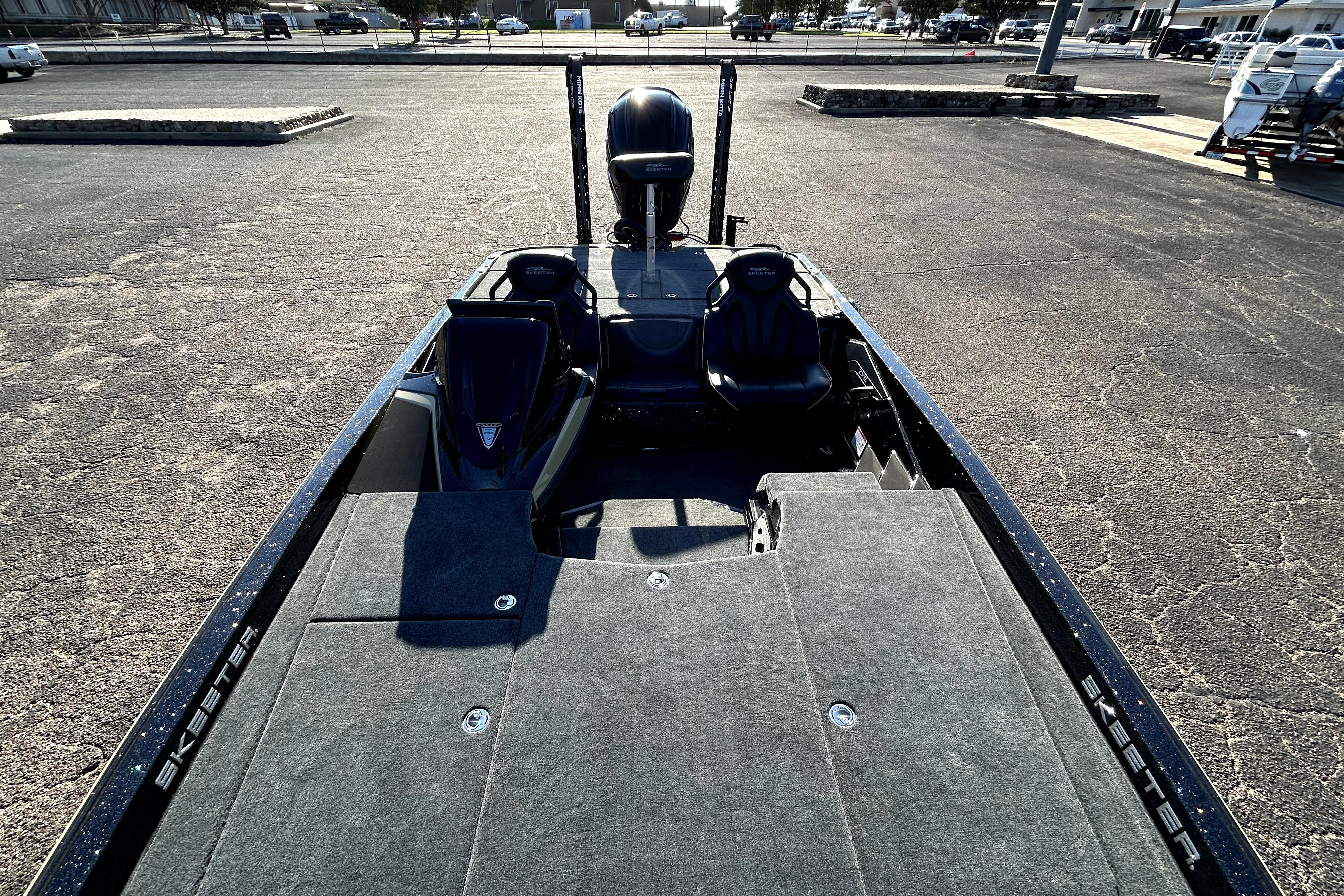 2026 Skeeter ZXE21 boat with spacious deck and seating in a parking lot.
