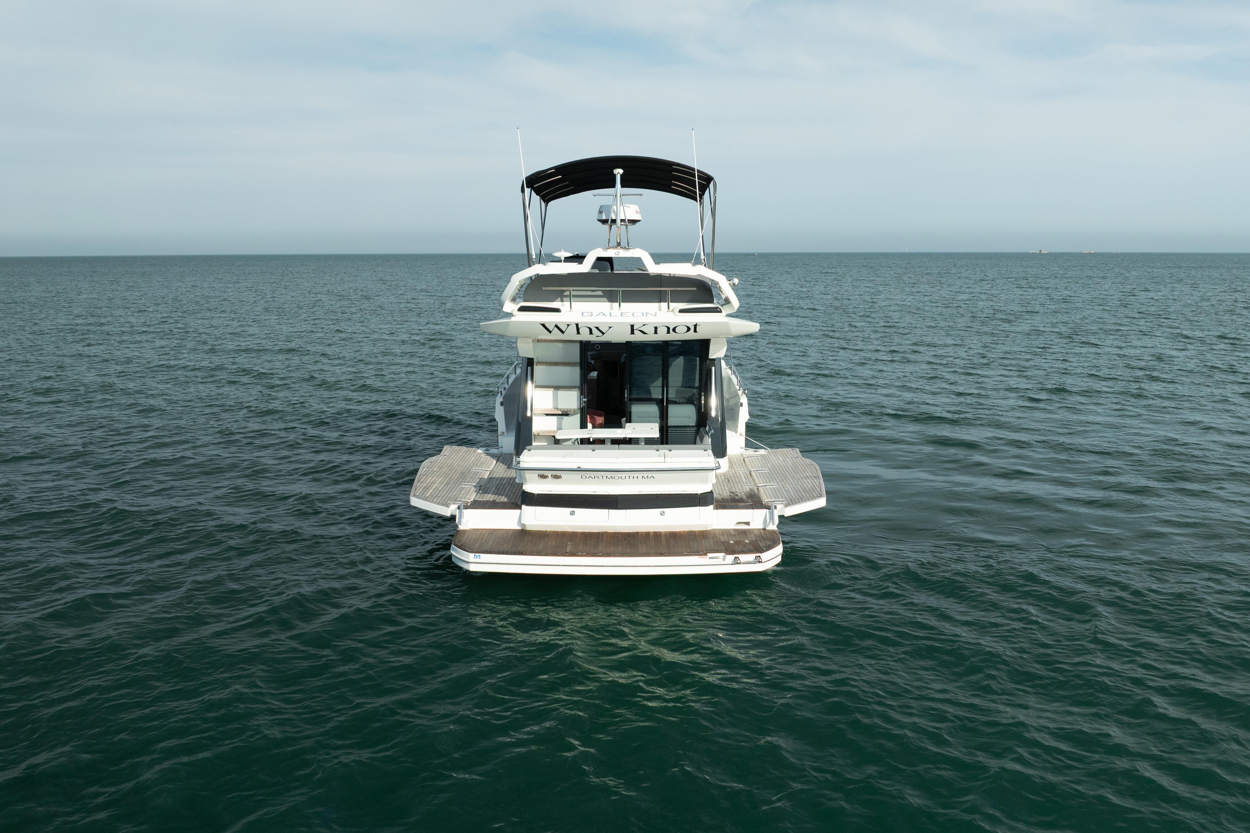 2023 Galeon 400 Fly yacht on open water, rear view.