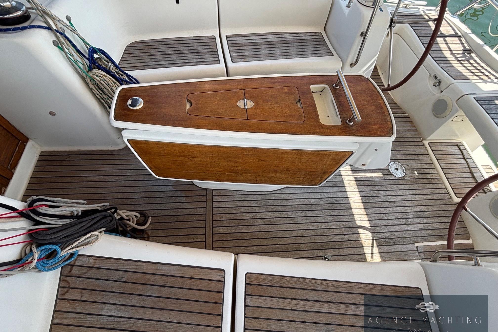 Cockpit of 2008 Beneteau Oceanis 40 sailboat with wooden table and seating.
