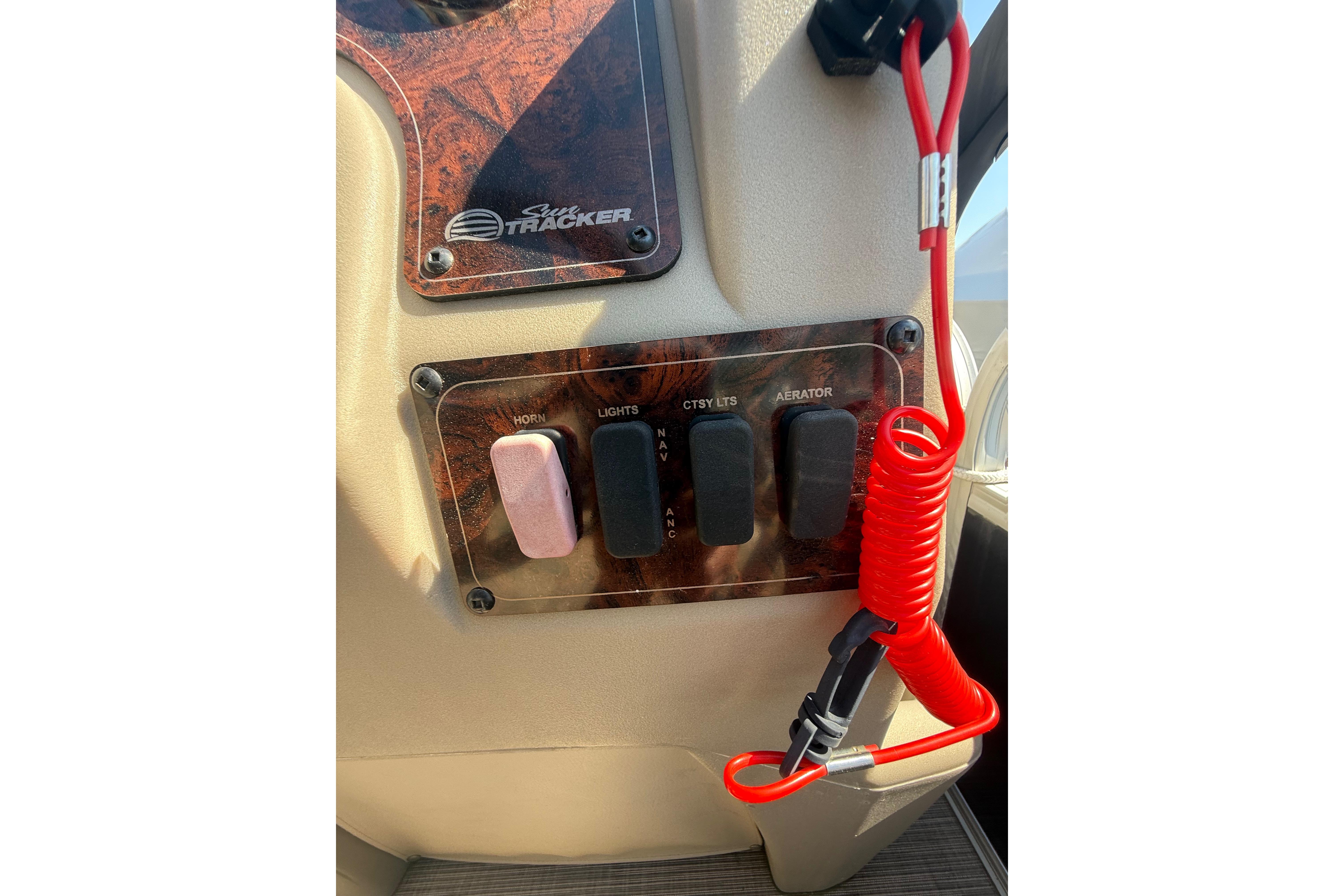 Control panel of 2021 Sun Tracker Bass Buggy 16 XL Select with switches and safety lanyard.