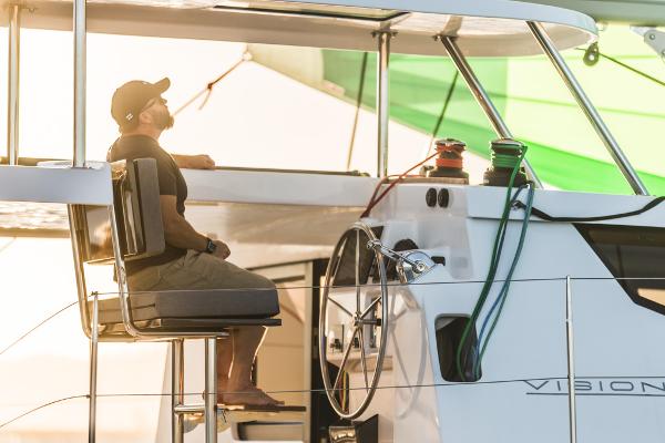 Man relaxing on Vision 444 yacht, 2025 model, enjoying the sunset.