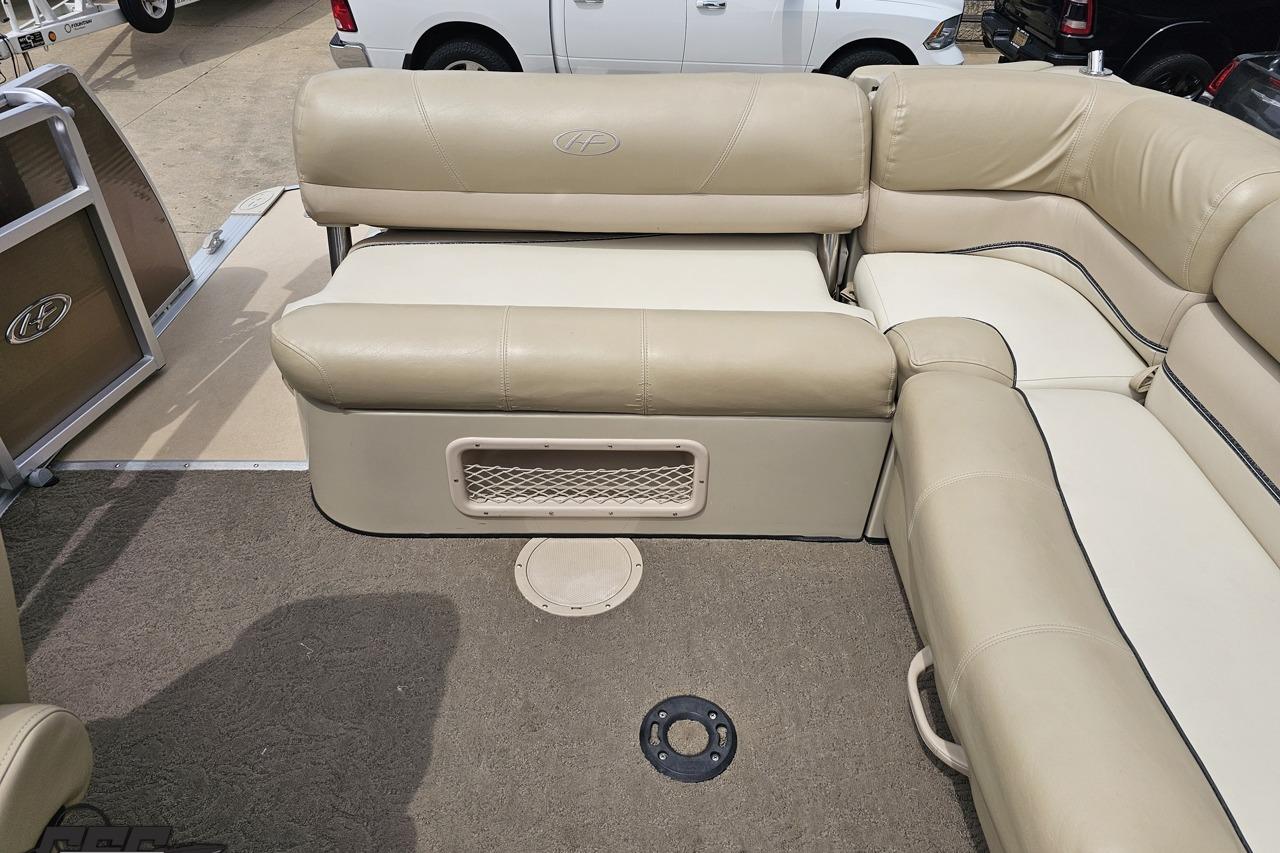 2012 Harris FloteBote 230 Grand Mariner SEL interior with beige seating and carpeted floor.