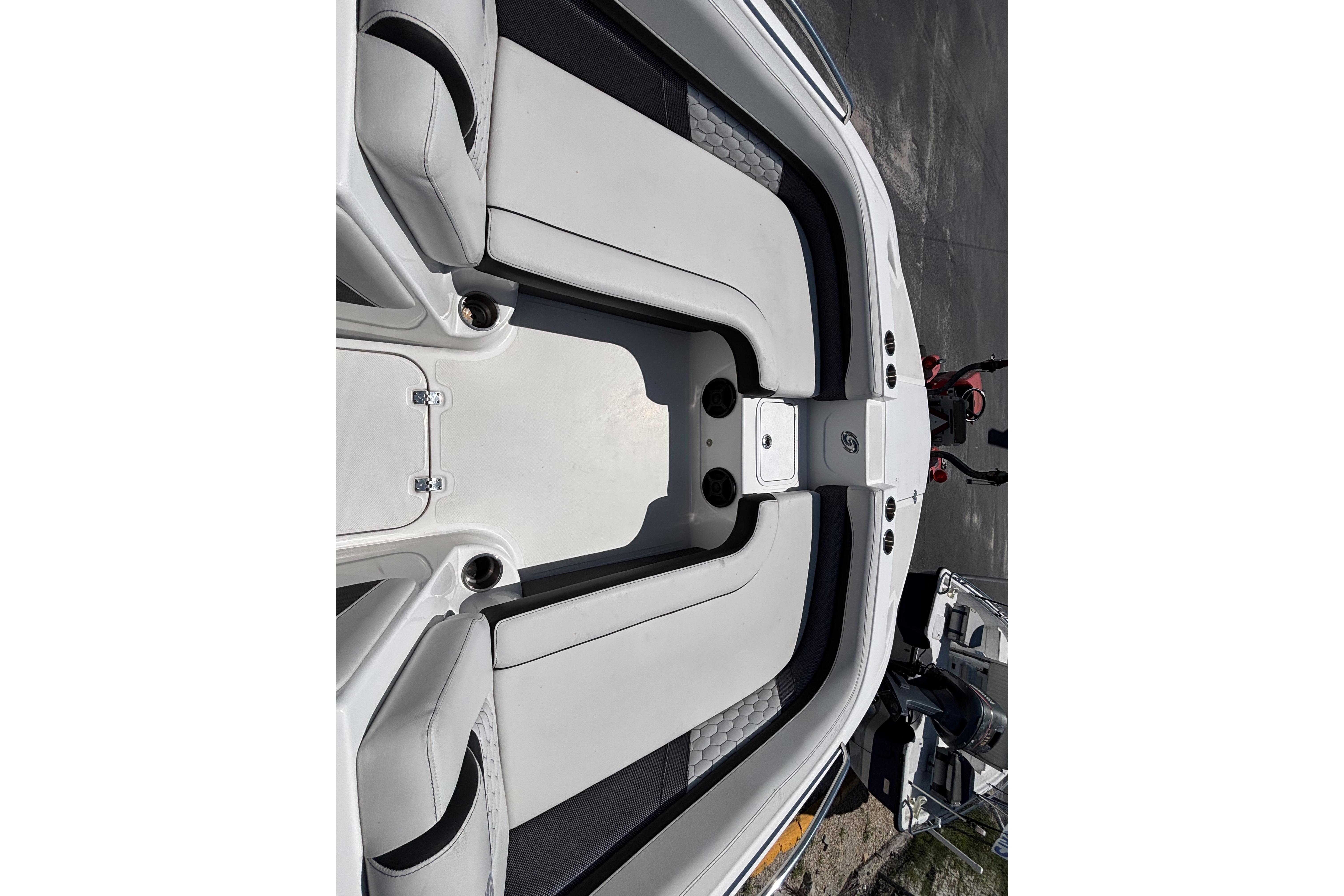 2019 Hurricane Sundeck Sport 218 OB boat interior with white seating and storage compartments.