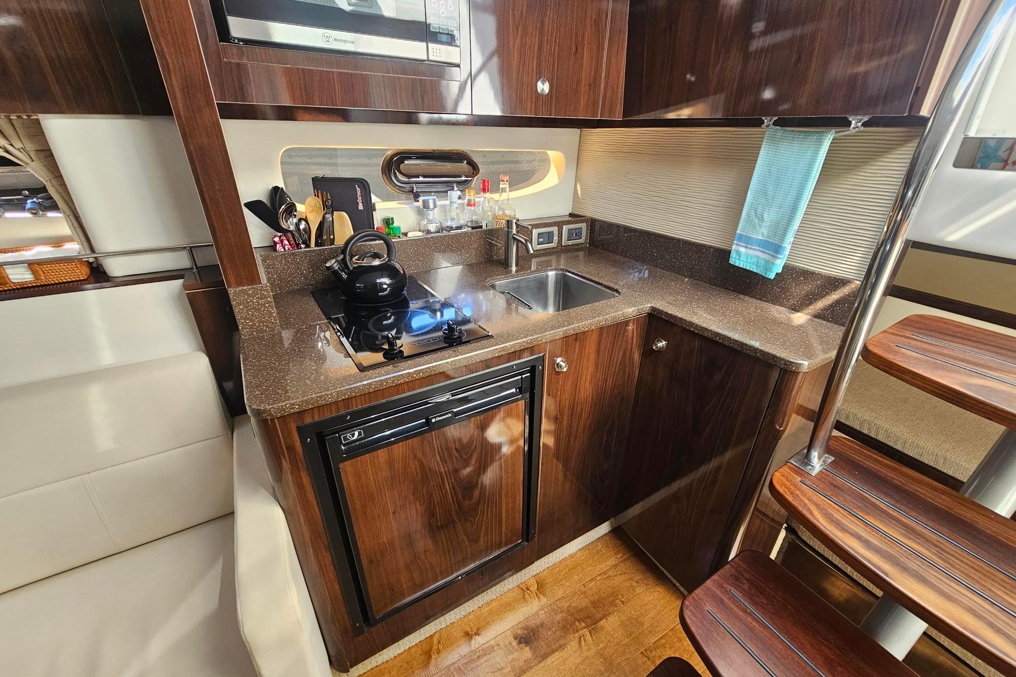 Luxurious 2016 Sea Ray Sundancer 350 yacht kitchen with modern amenities and sleek design.