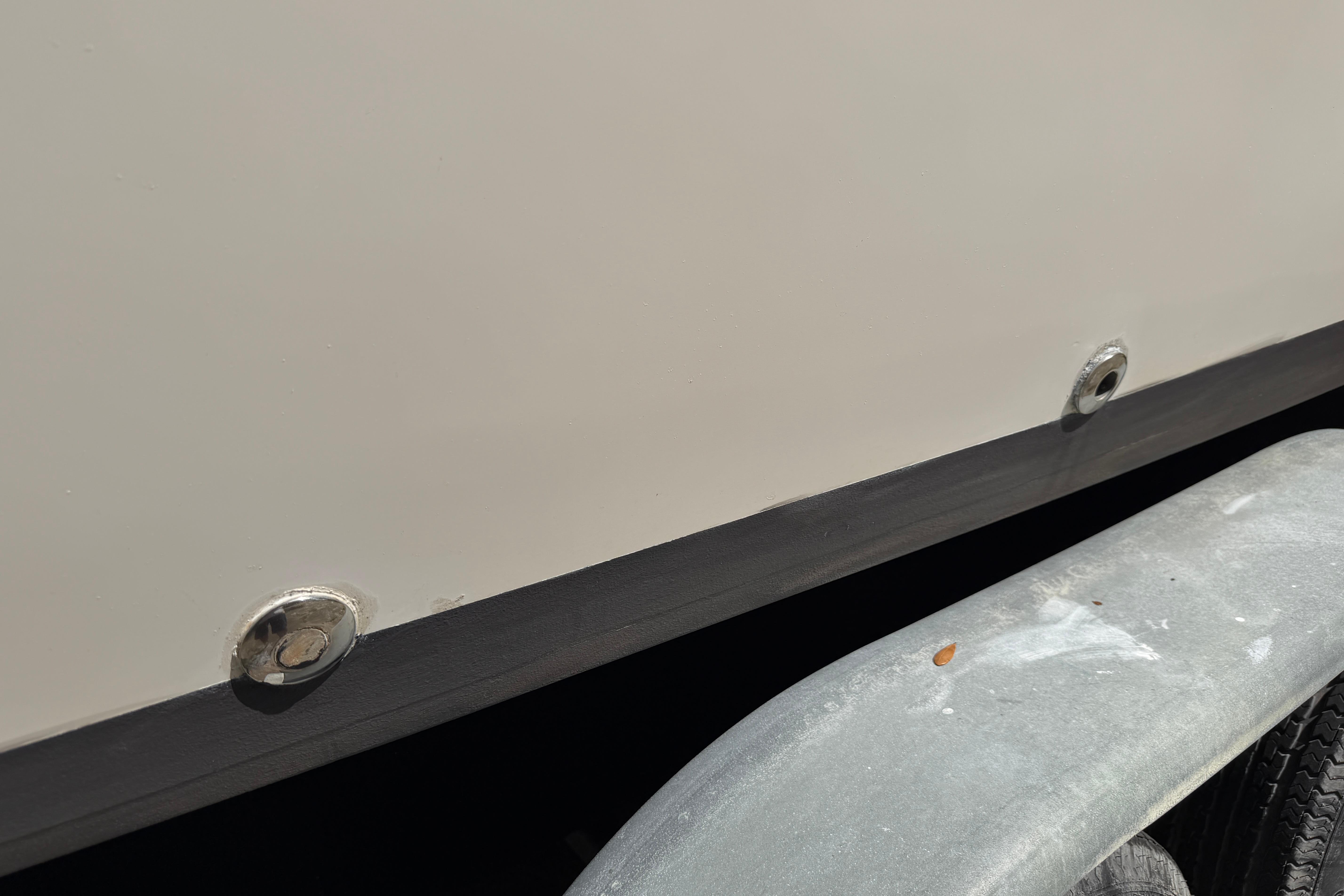 Close-up of 1987 Grady-White Seafarer 226 boat hull and trailer detail.