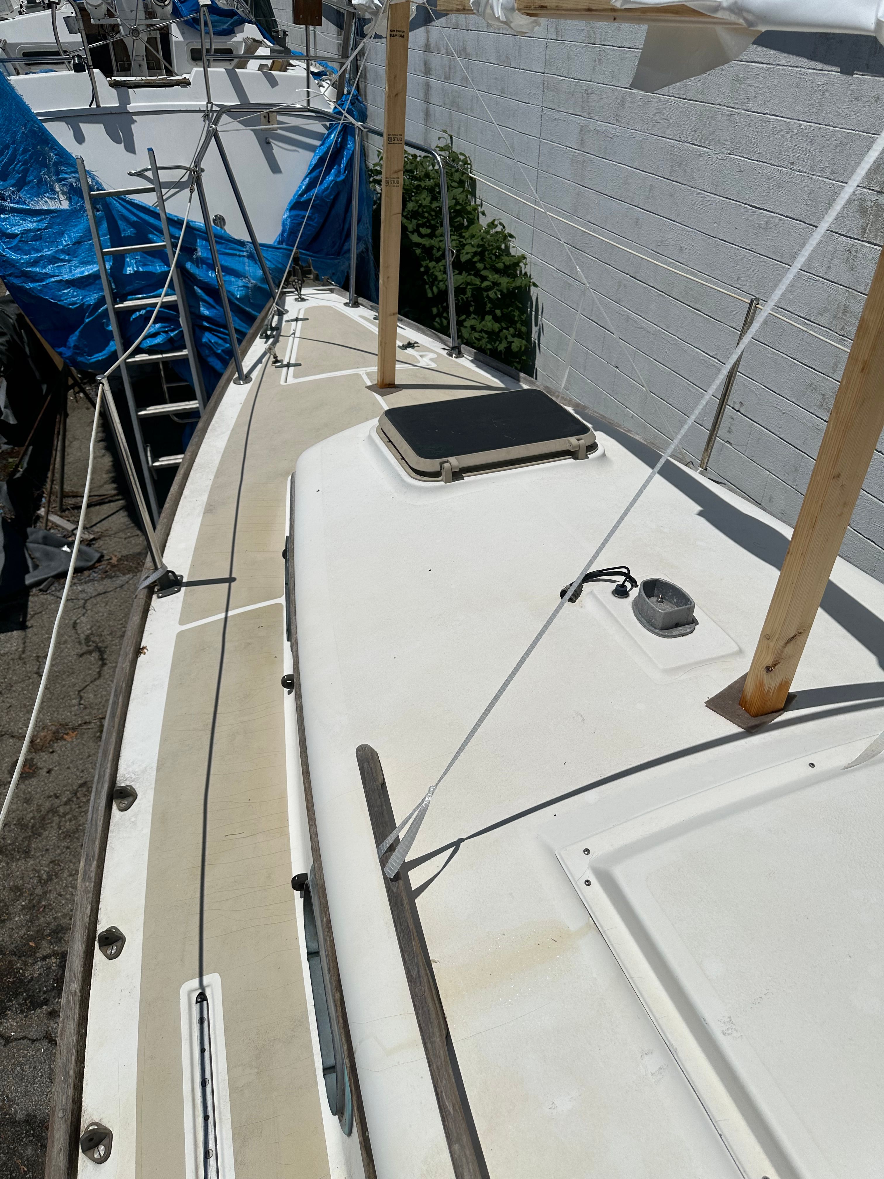 Deck view of a 1985 Cape Dory 25D with hatches and railing.