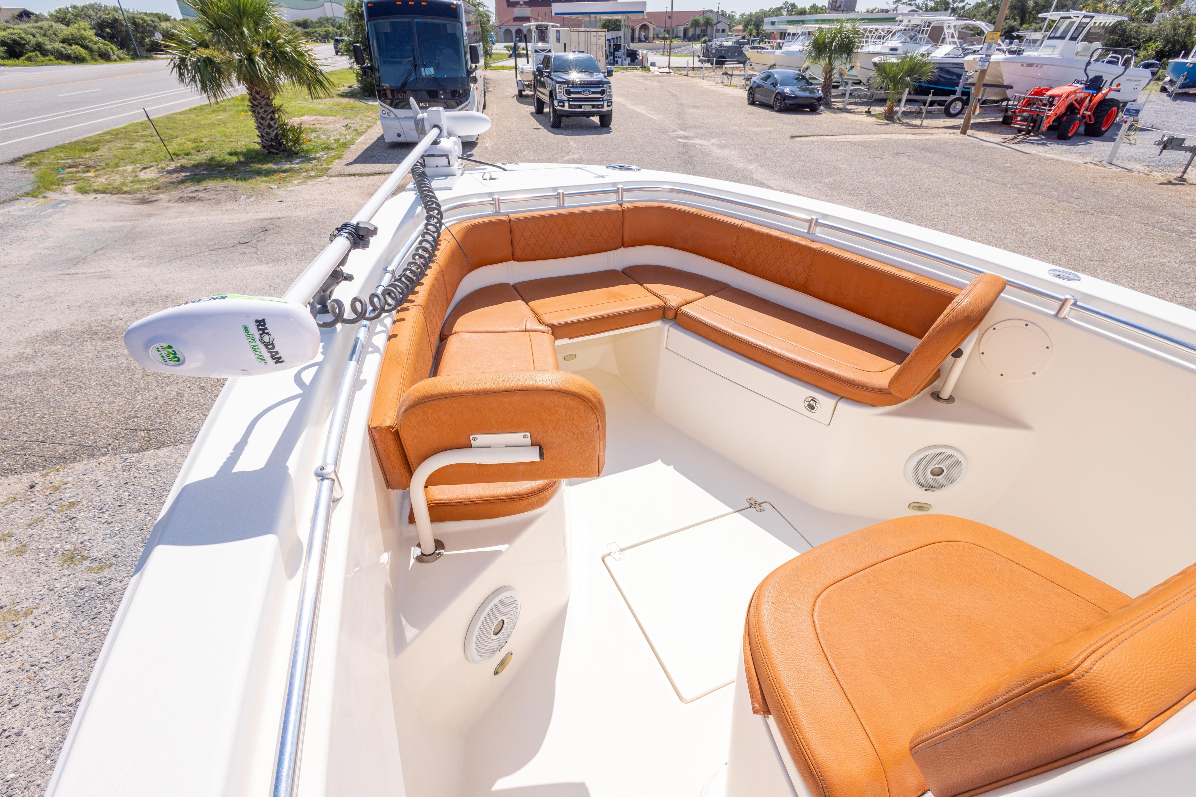 2017 Cobia 261 Center Console boat with tan seating and trolling motor.
