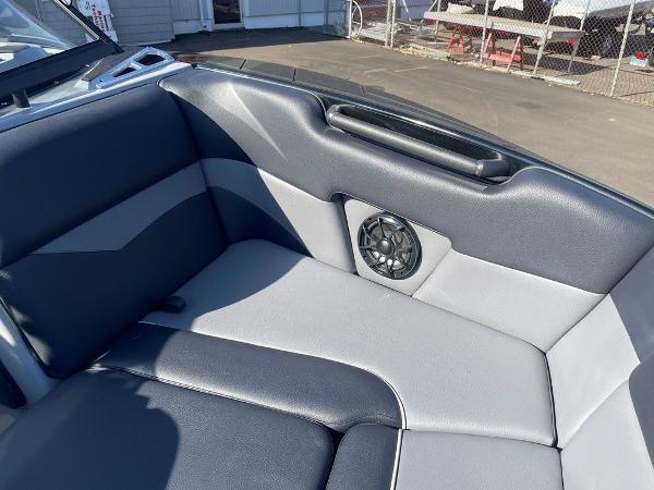 2025 Moomba Mondo boat interior with black and gray seating and built-in speaker.
