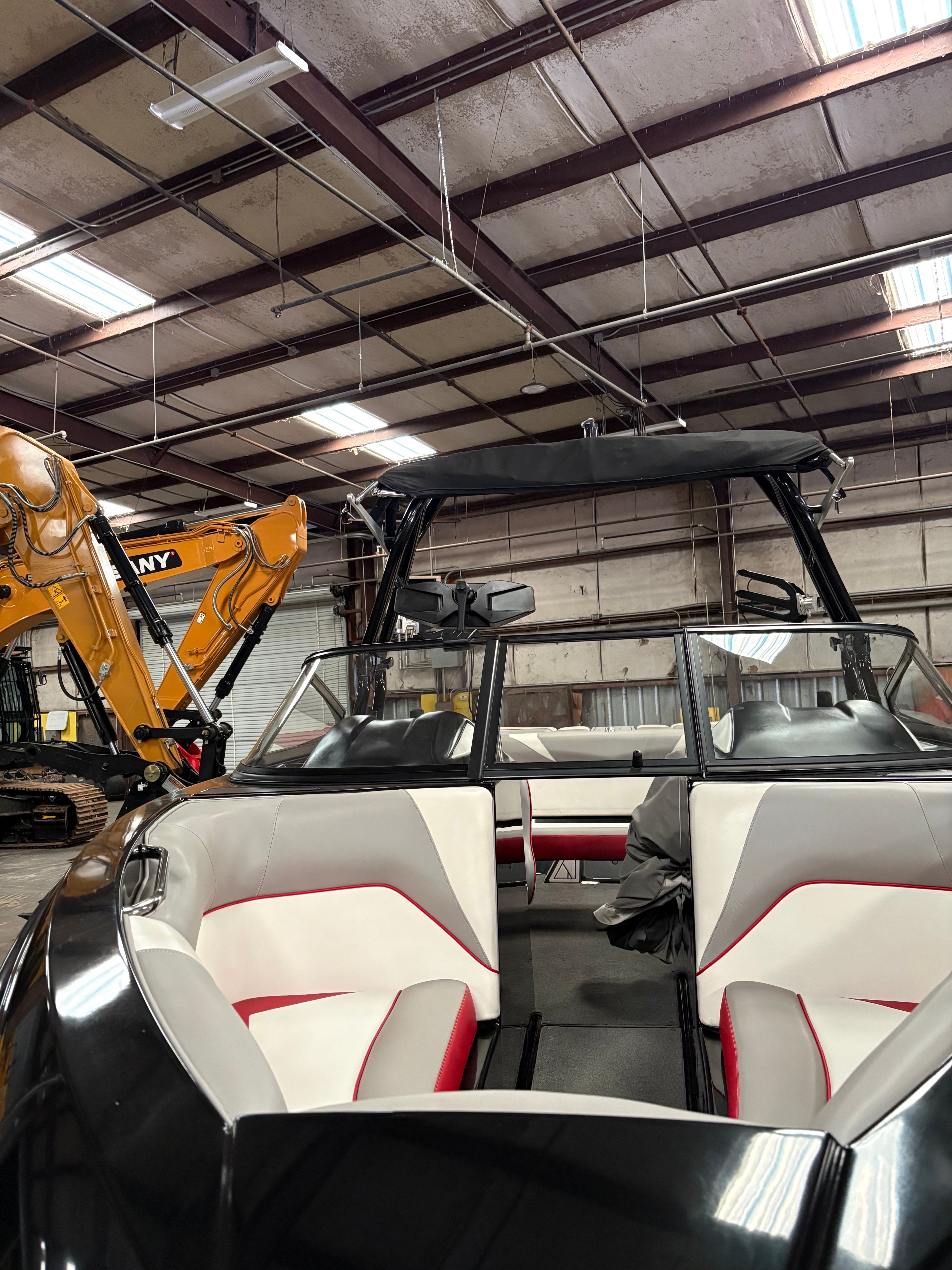 2019 Moomba Craz boat in warehouse with excavator.