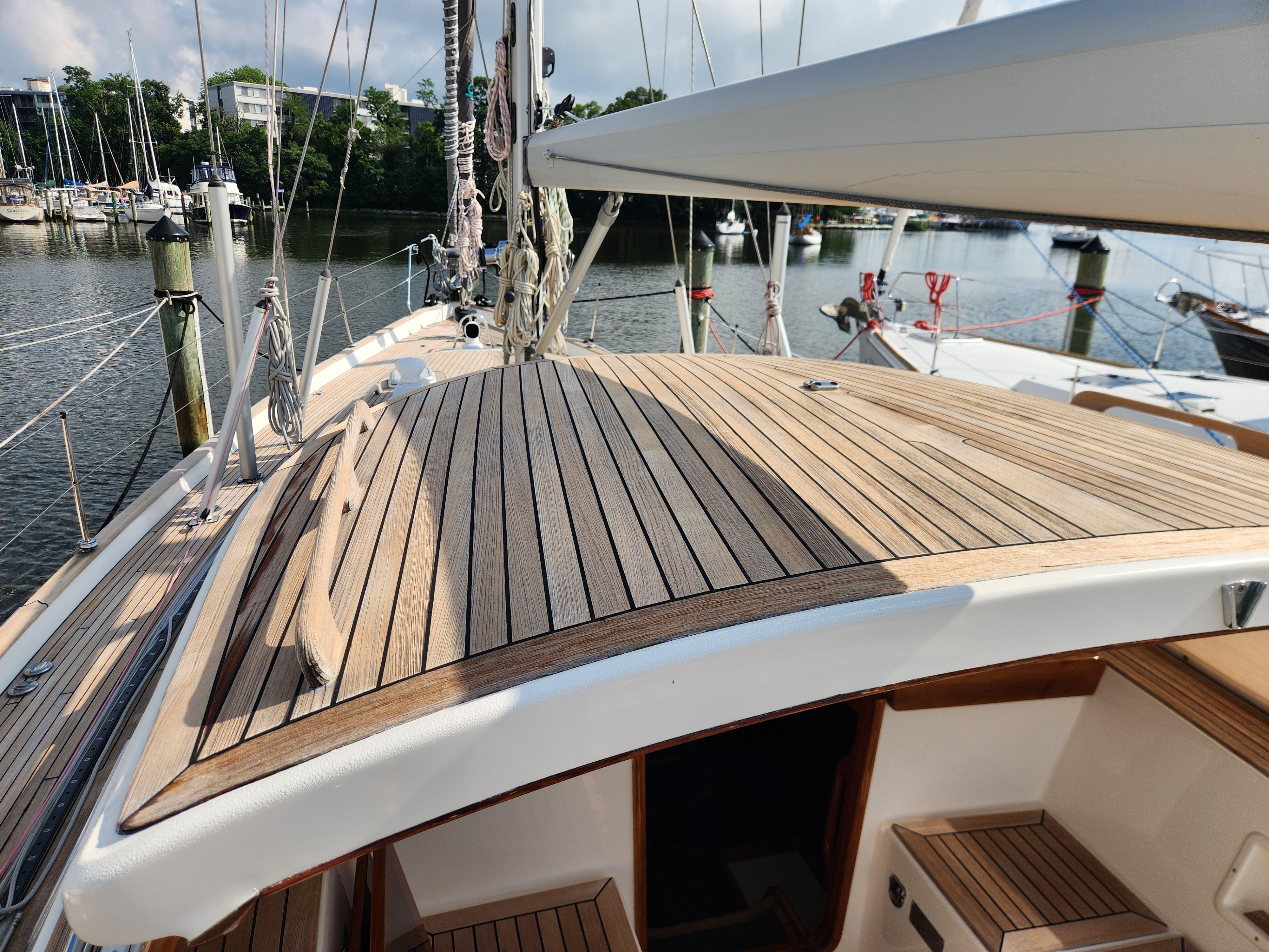 2006 Hallberg-Rassy 48 sailboat with teak deck, docked in a marina.