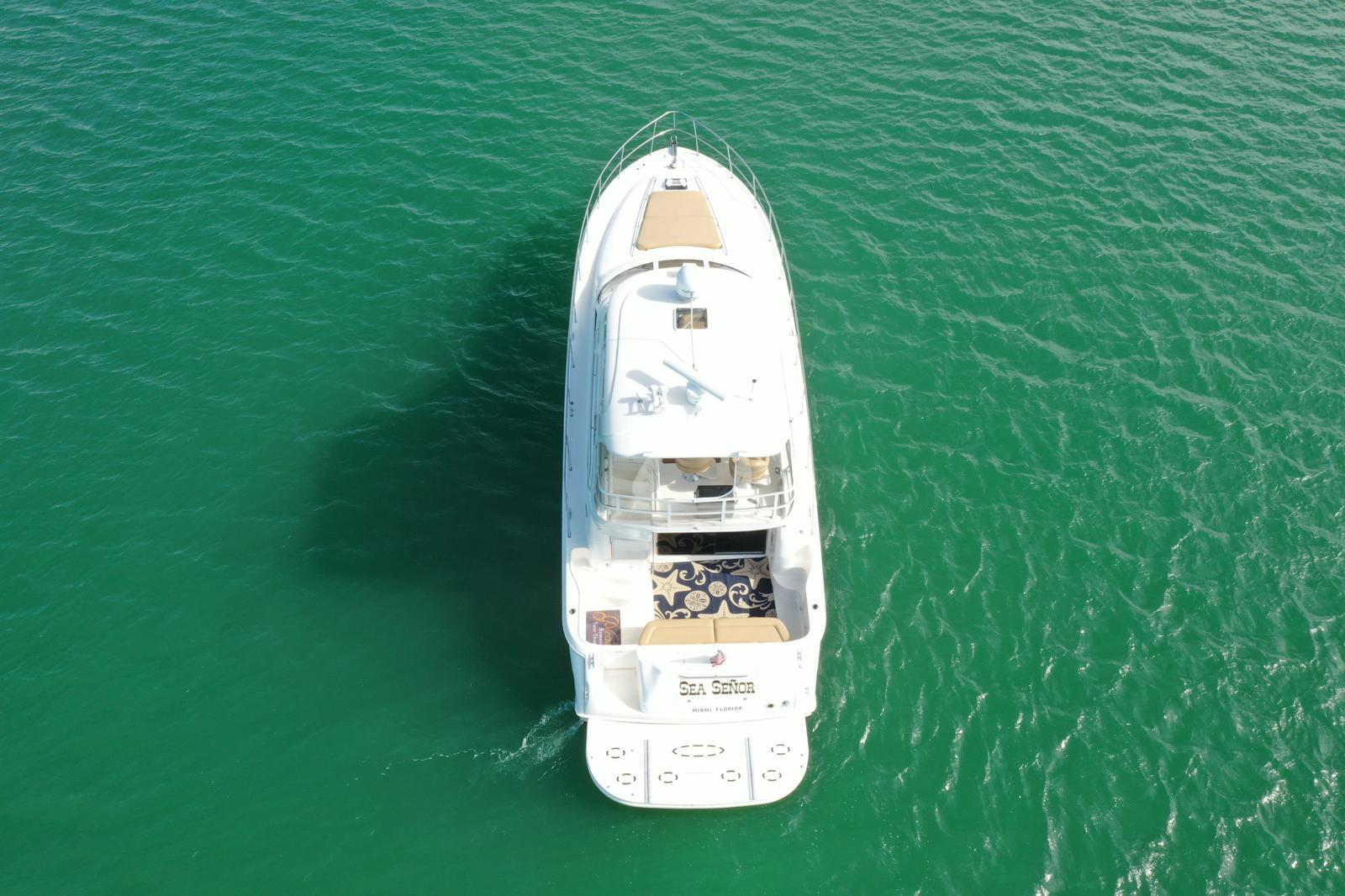 Aerial view of 2001 Sea Ray 480 Sedan Bridge yacht on turquoise water.