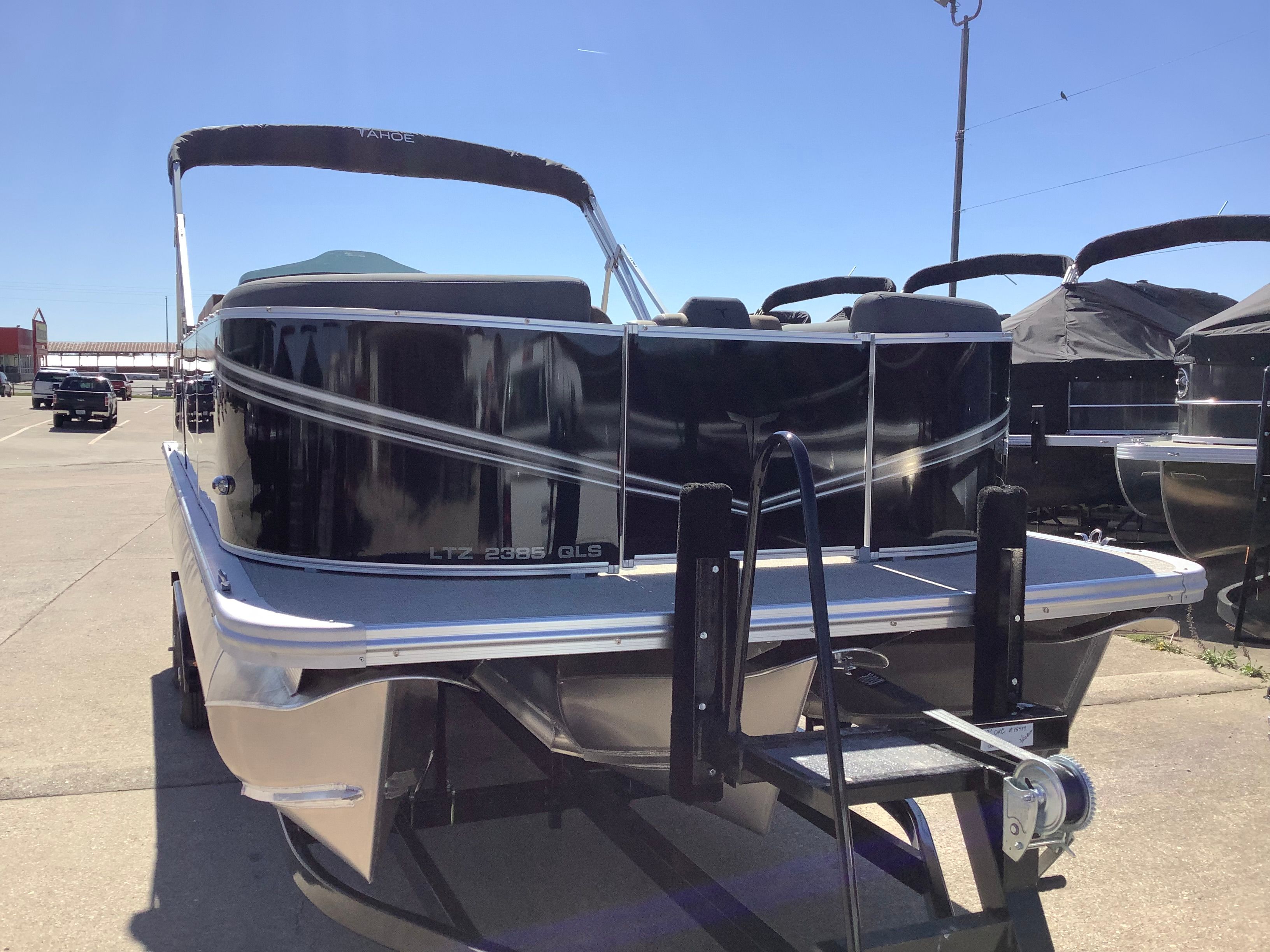 2026 Tahoe 2385 LTZ Quad Lounger boat on trailer outdoors.