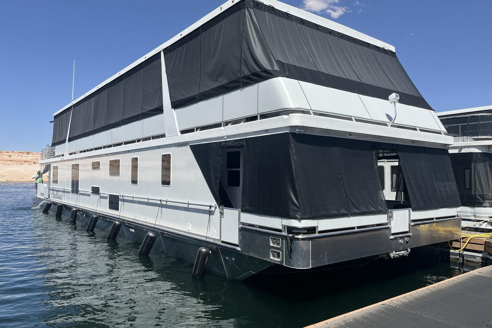2025 Sumerset Excellence Multiple Shares houseboat docked on a sunny day.