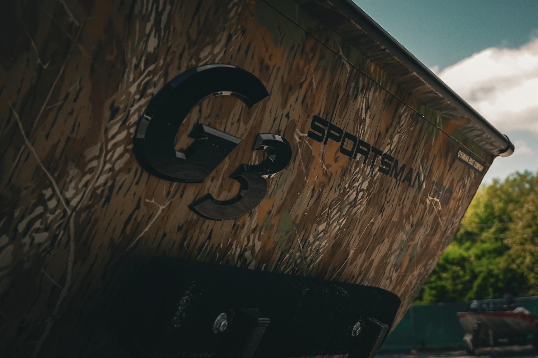 2026 G3 Sportsman 1710 boat with camouflage design, close-up view.