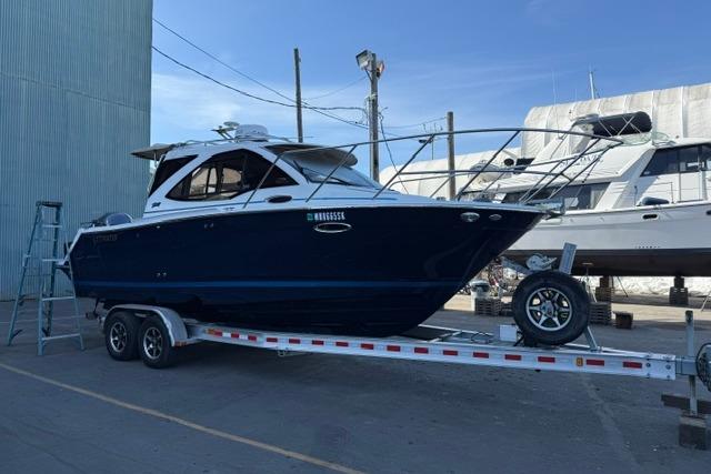 2017 Cutwater C-242 Coupe boat on trailer, dockside view.