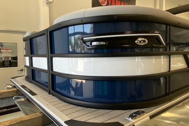 2026 Bentley Pontoons Elite 223 Swingback, sleek blue and white design, showcased indoors.