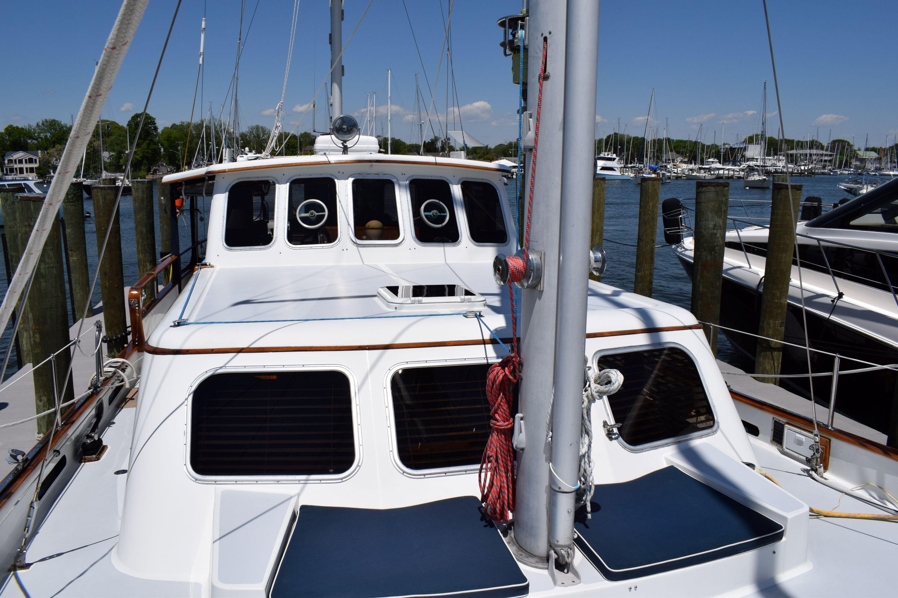 1980 Cheoy Lee 52 Motorsailer docked at marina, showcasing deck and cabin features.