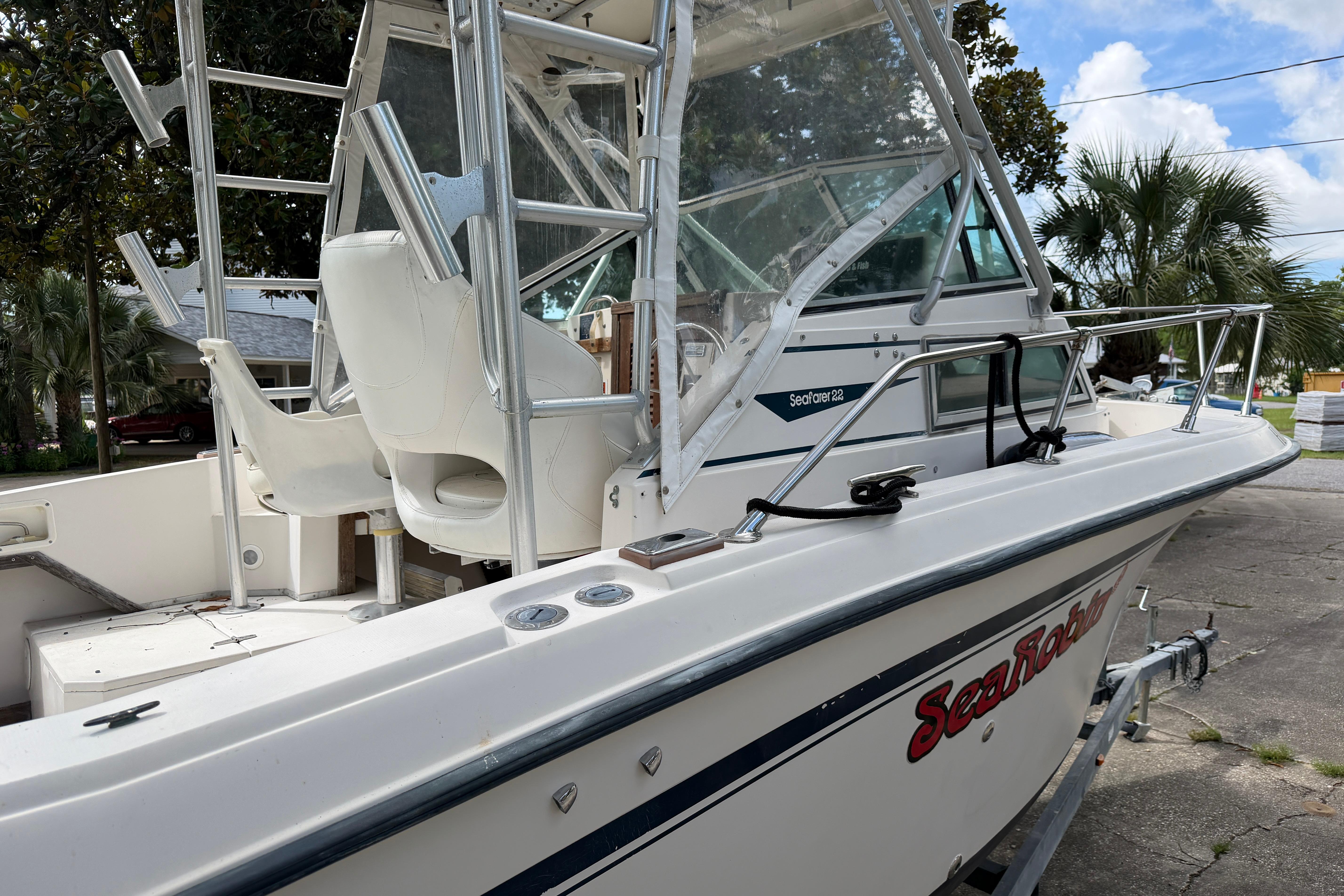 1987 Grady-White Seafarer 226 boat with white seating and metal railings, parked outdoors.