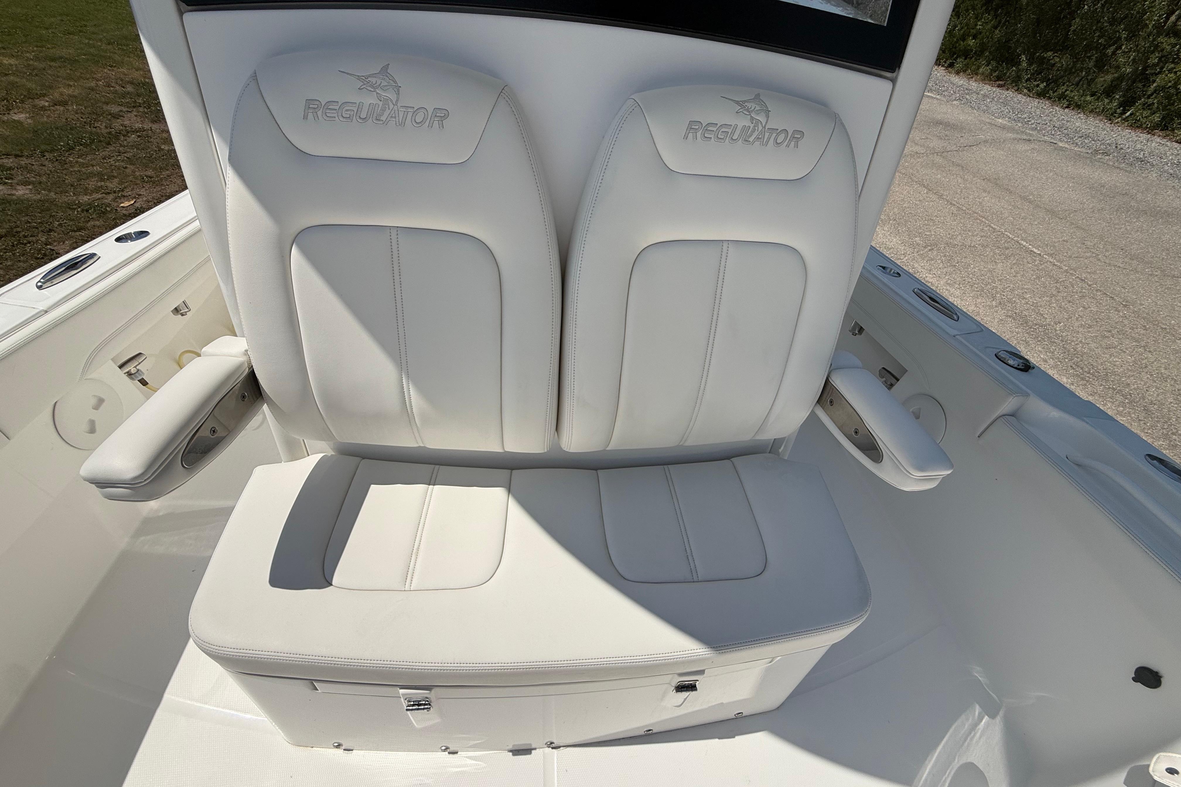 2023 Regulator 26XO boat seating with white cushioned seats and armrests.
