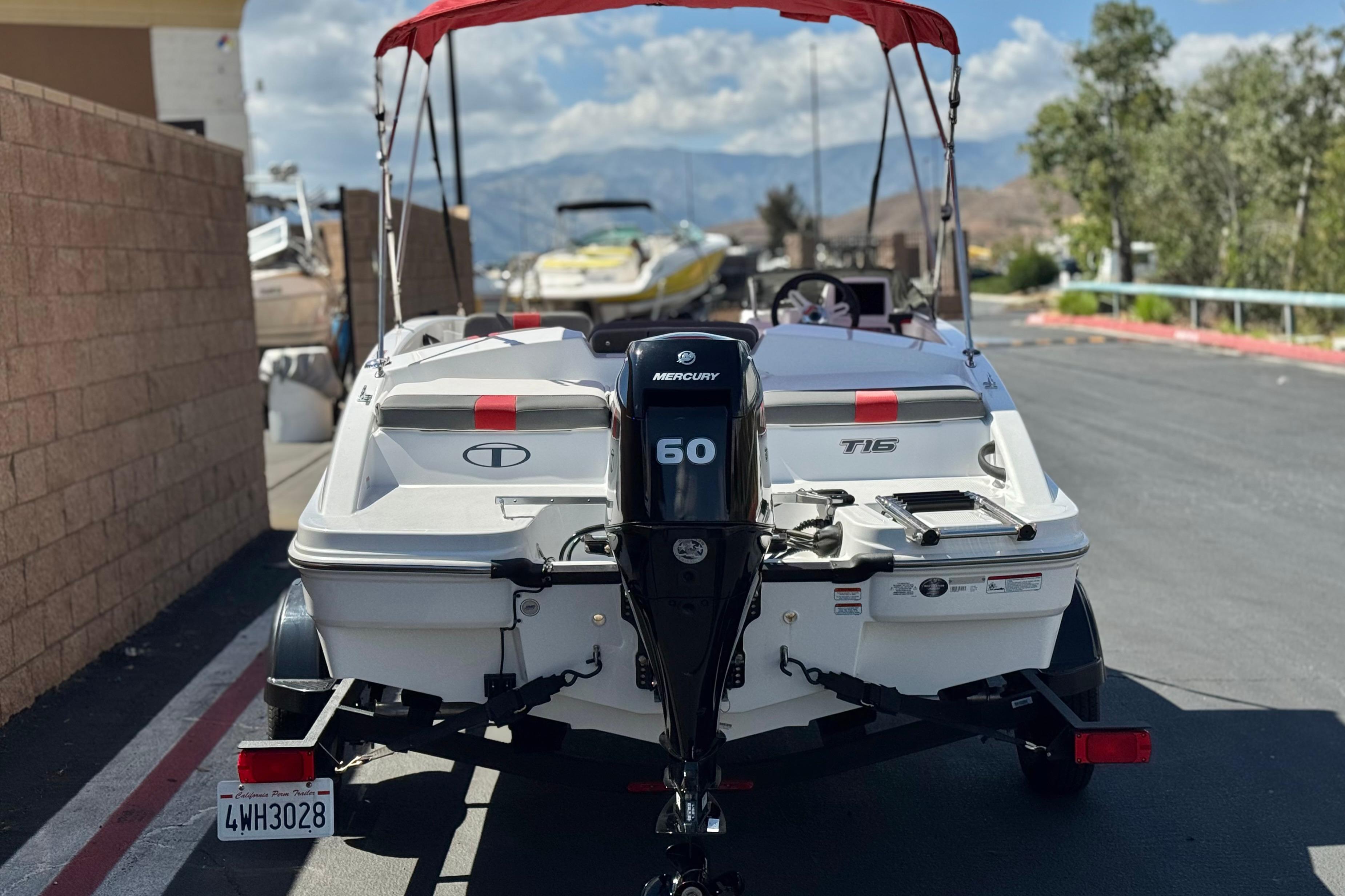 2024 Tahoe T16 boat with Mercury 60 engine, parked outdoors.