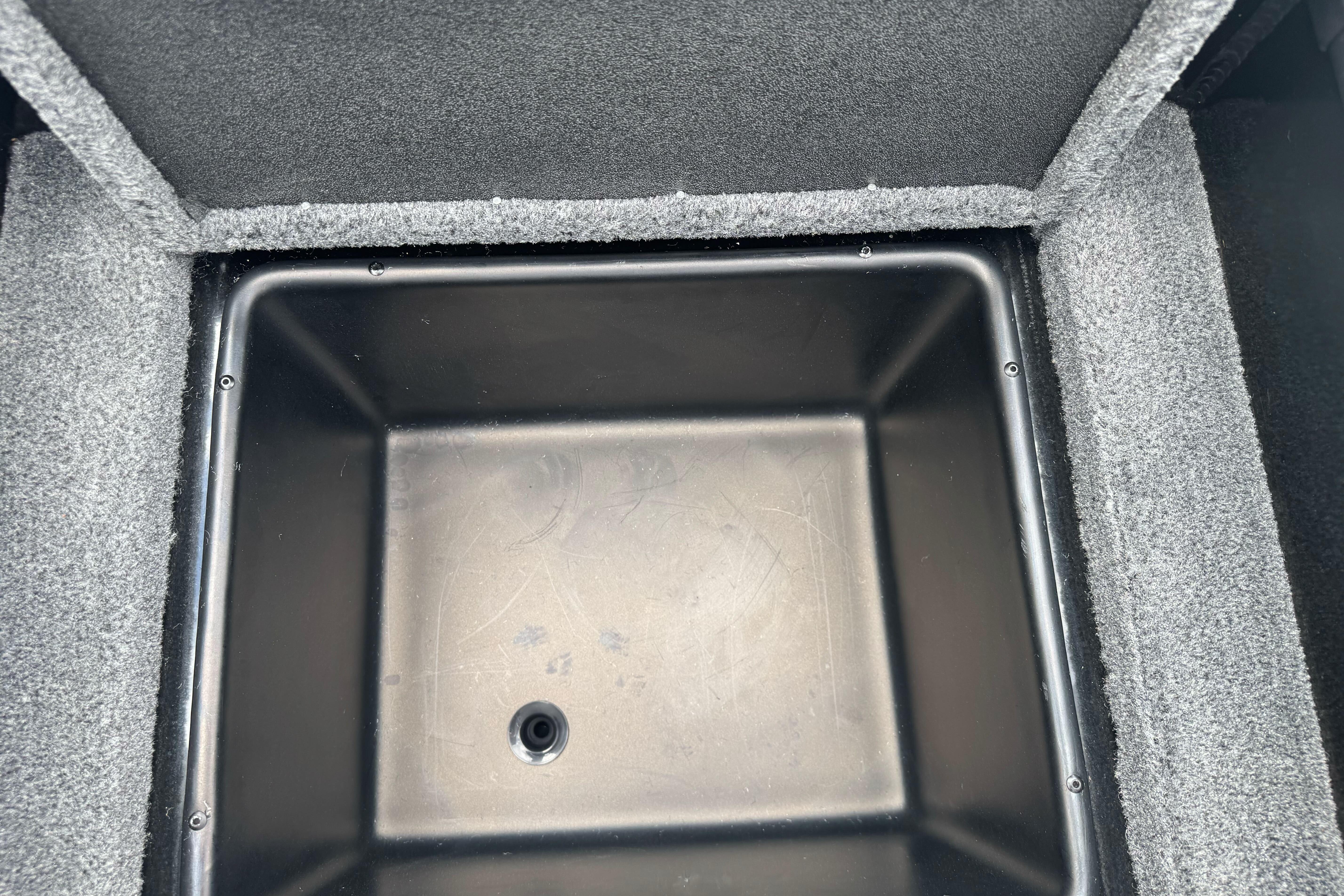 Interior storage compartment of 2026 Ranger ALPHA 208, featuring a black plastic bin.