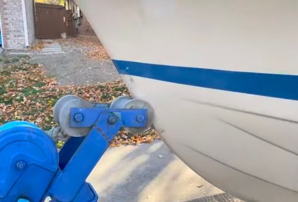 1962 Larsen 13 boat on a blue trailer.