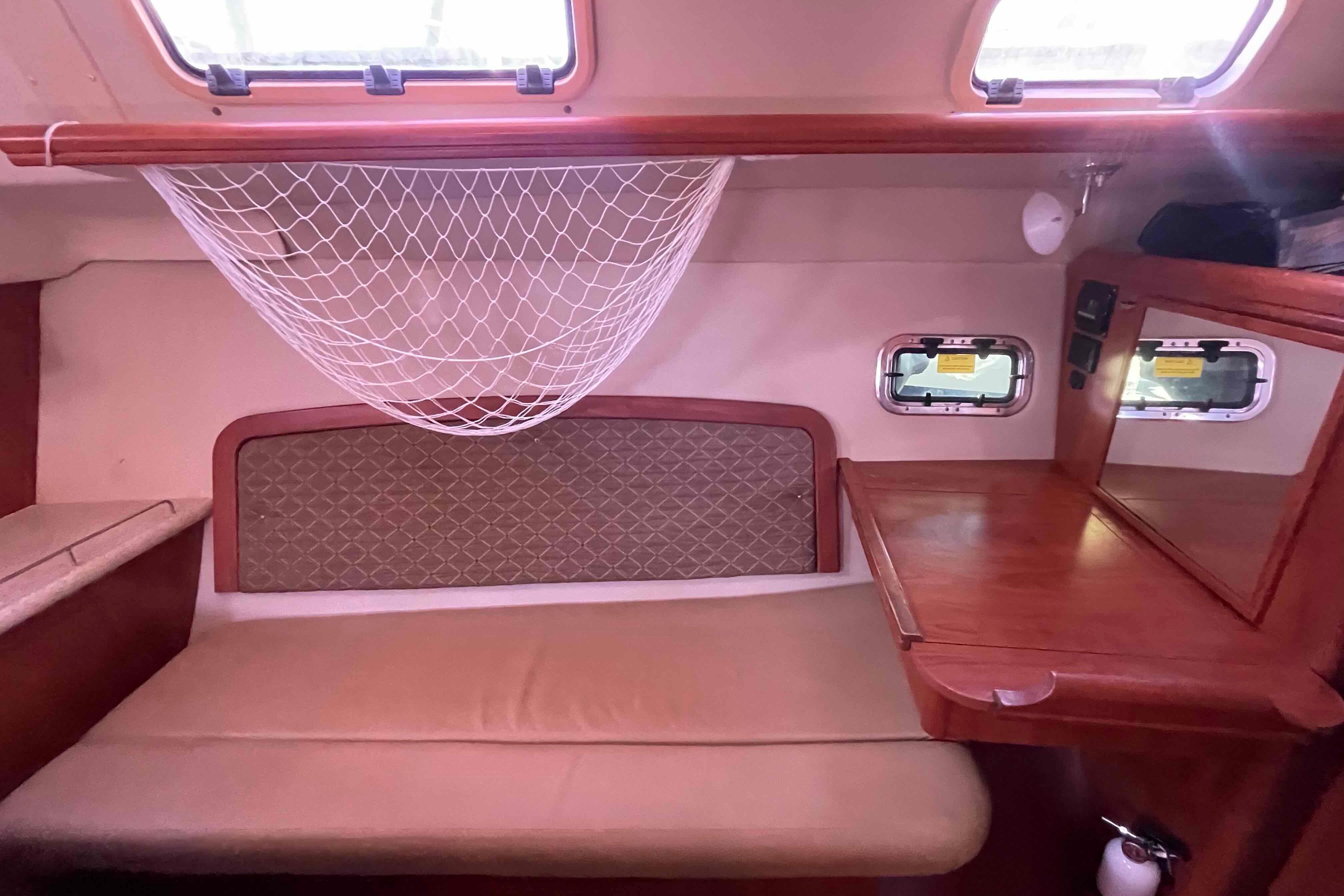 Interior of 2010 Hunter 45 Center Cockpit with cozy seating and wooden table.