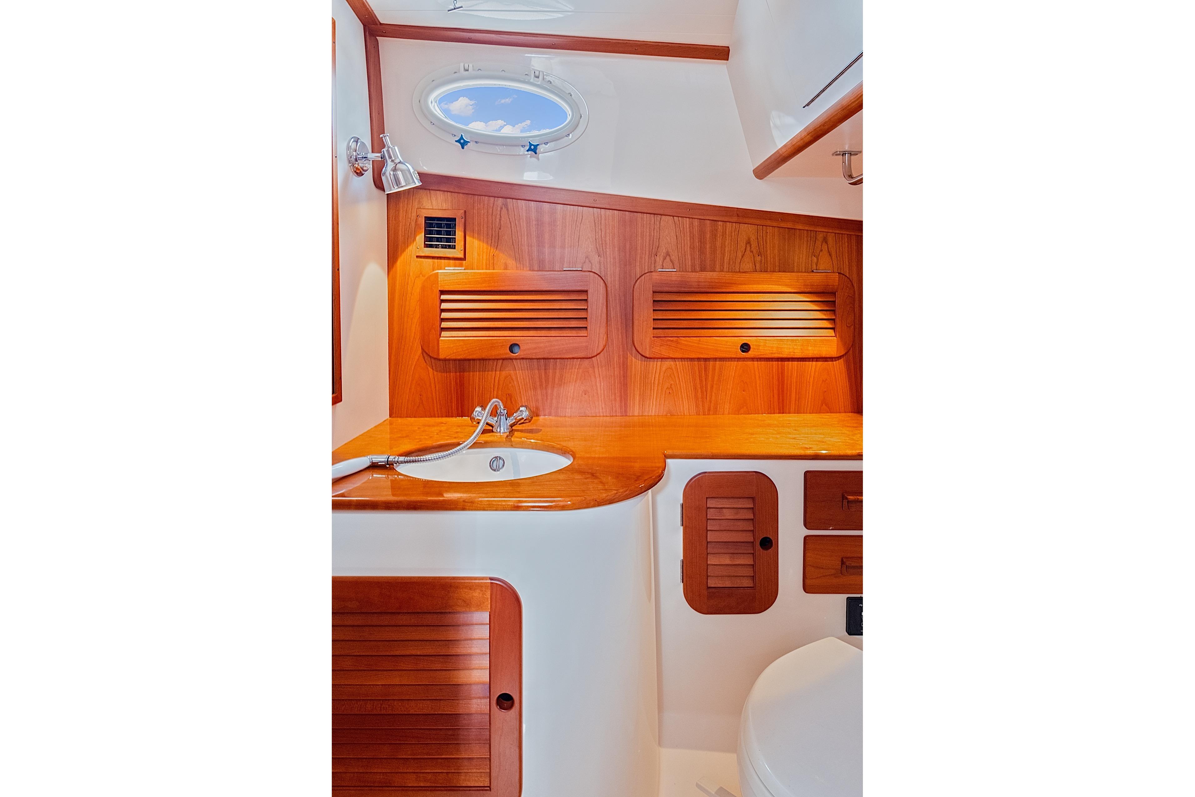 Elegant wooden interior of 2018 Hinckley Picnic Boat 37 MKIII bathroom.
