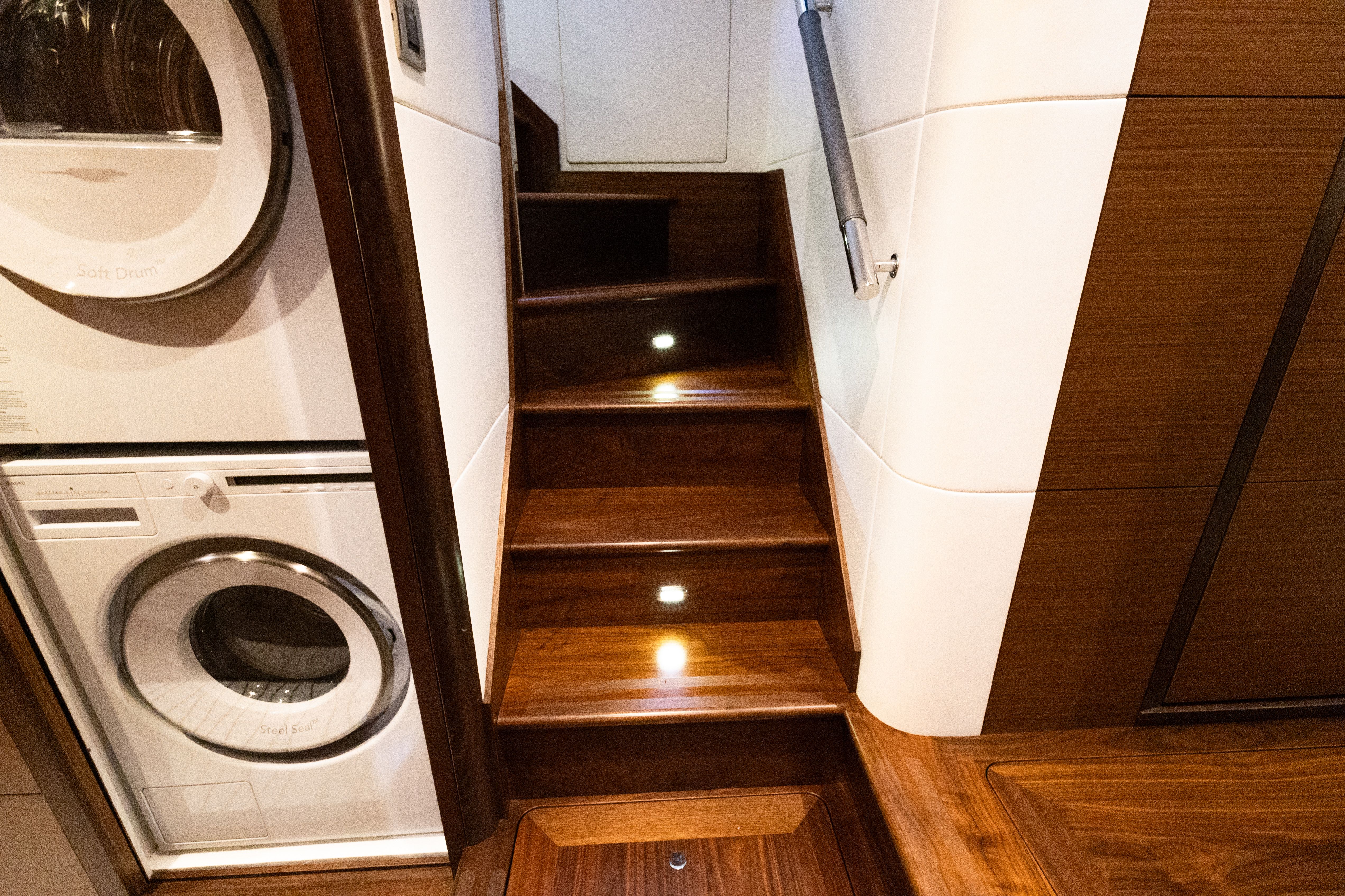 Interior of 2017 Ocean Alexander Evolution with washer and wooden stairs.