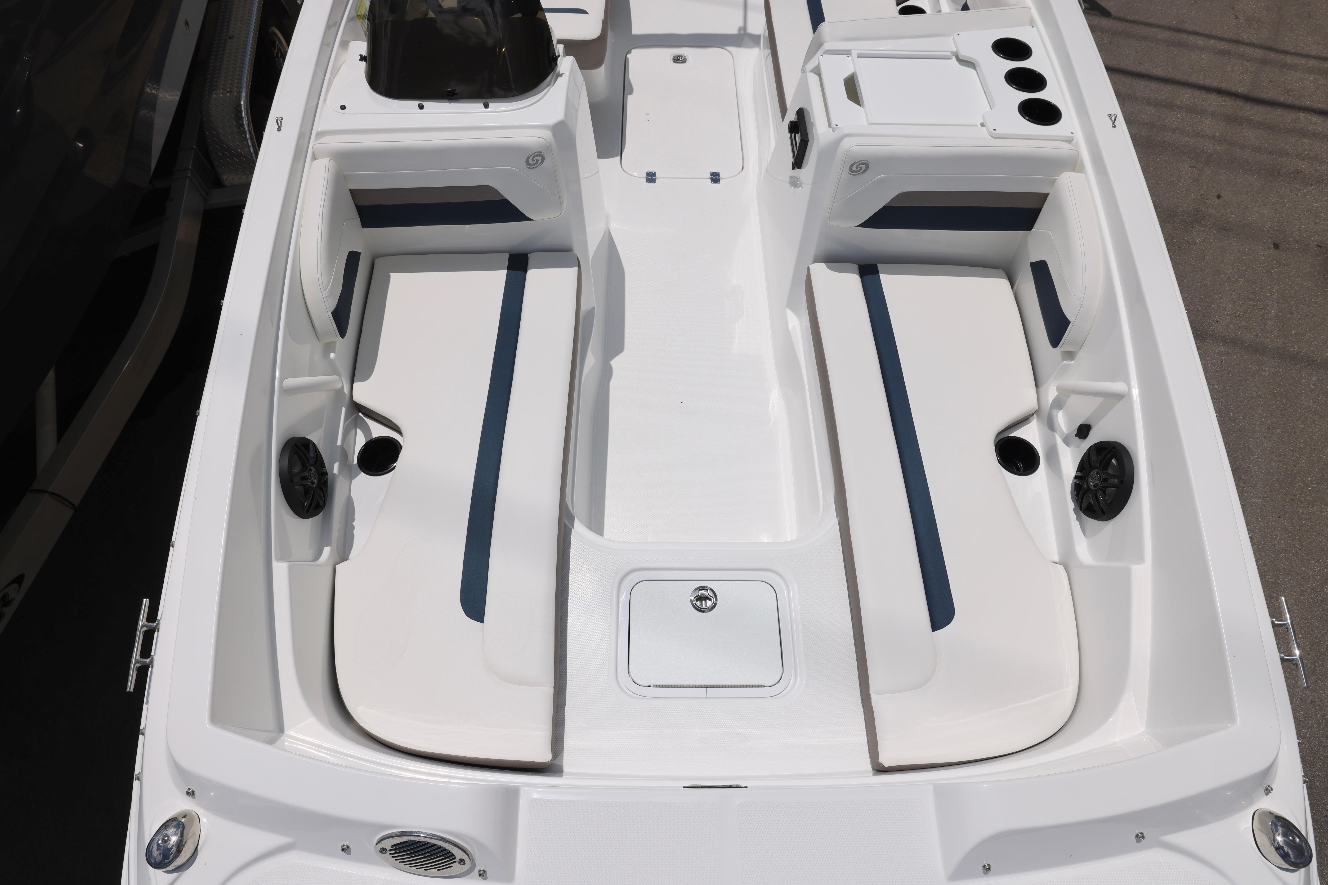 2026 Hurricane SunDeck Sport 205 OB boat interior with white seating and blue accents.