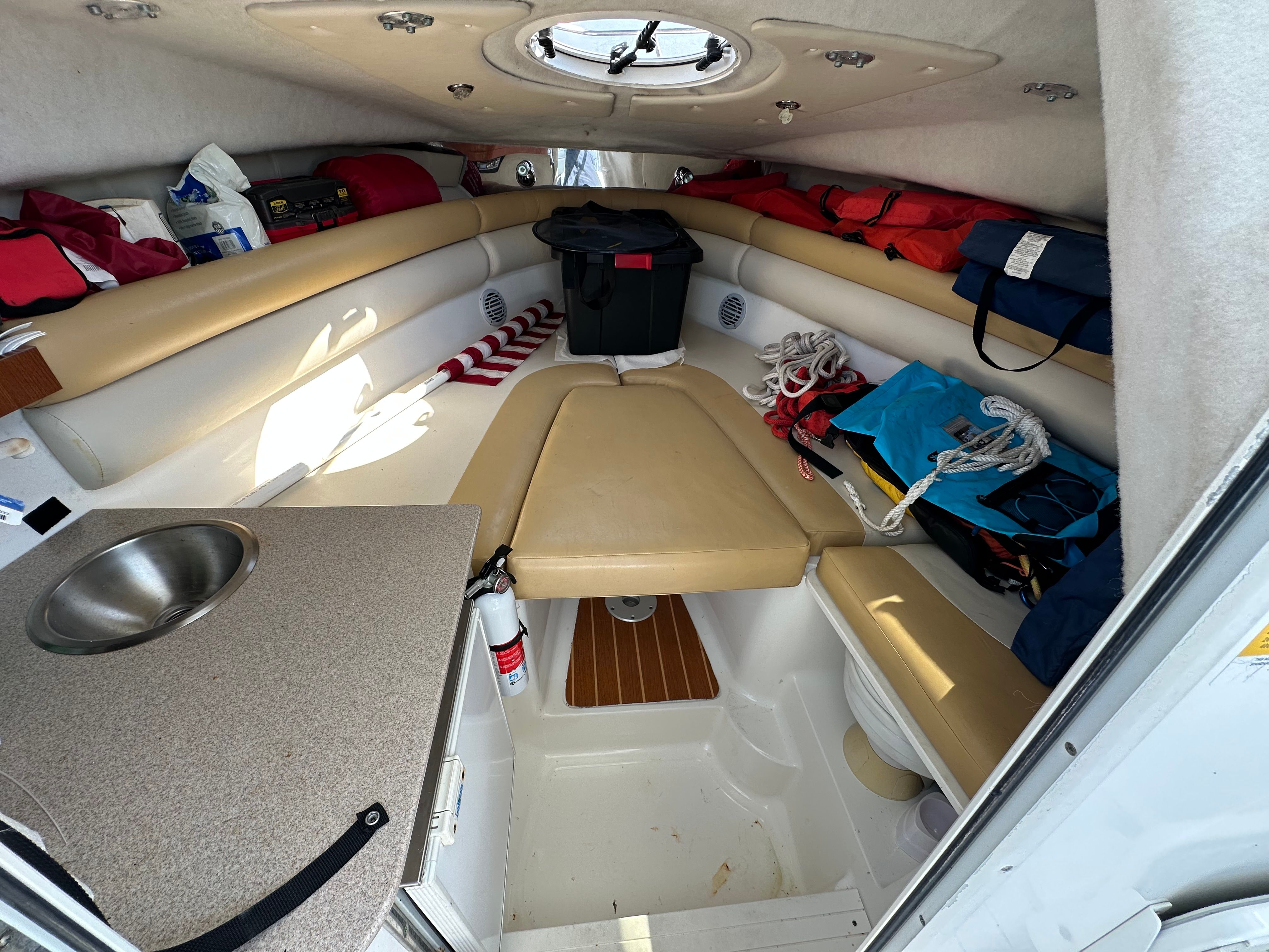 Interior of a 2009 Sea Fox 256WA with seating area, sink, and storage.