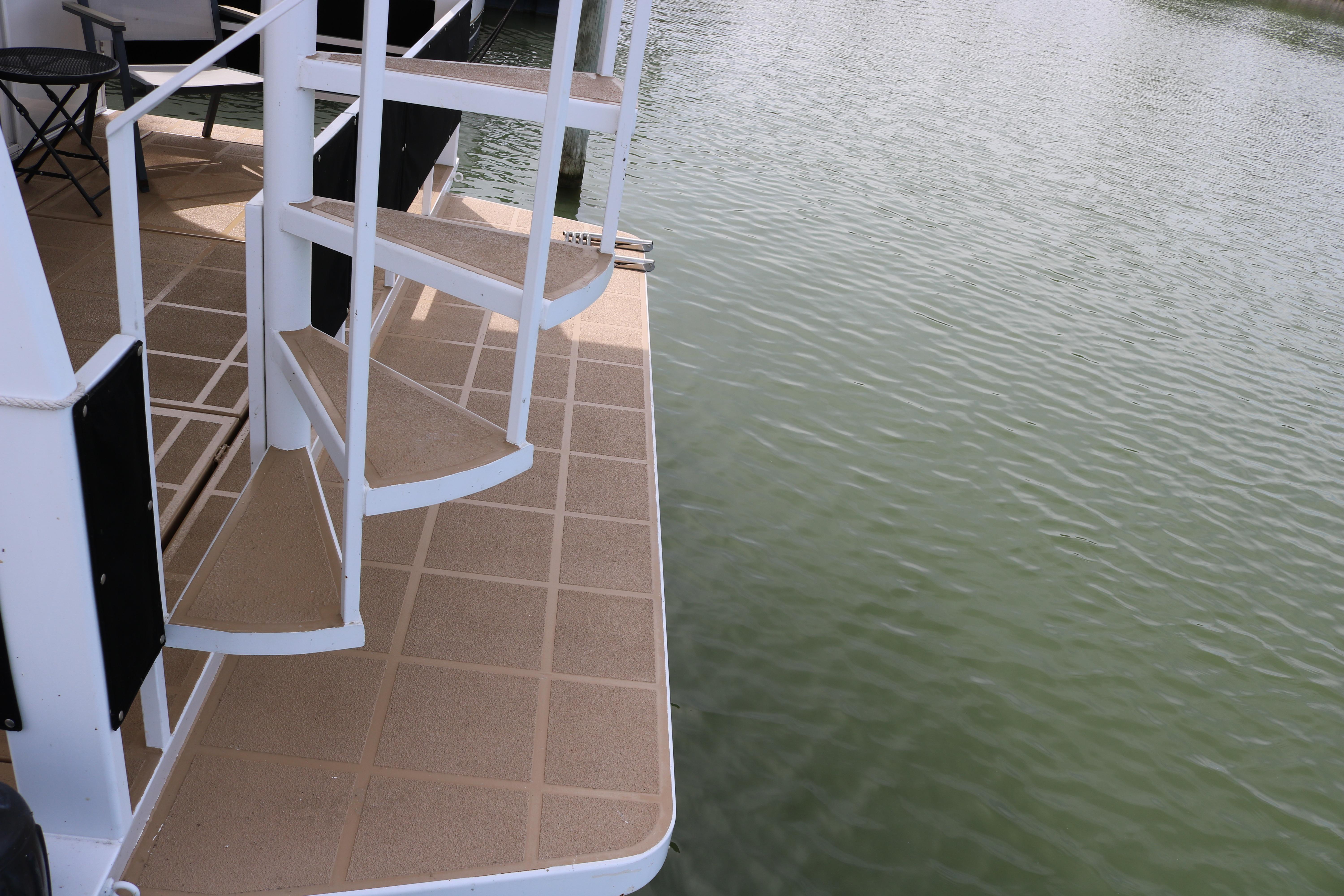 Staircase on 2010 Skipperliner 480 Flybridge yacht by the water.