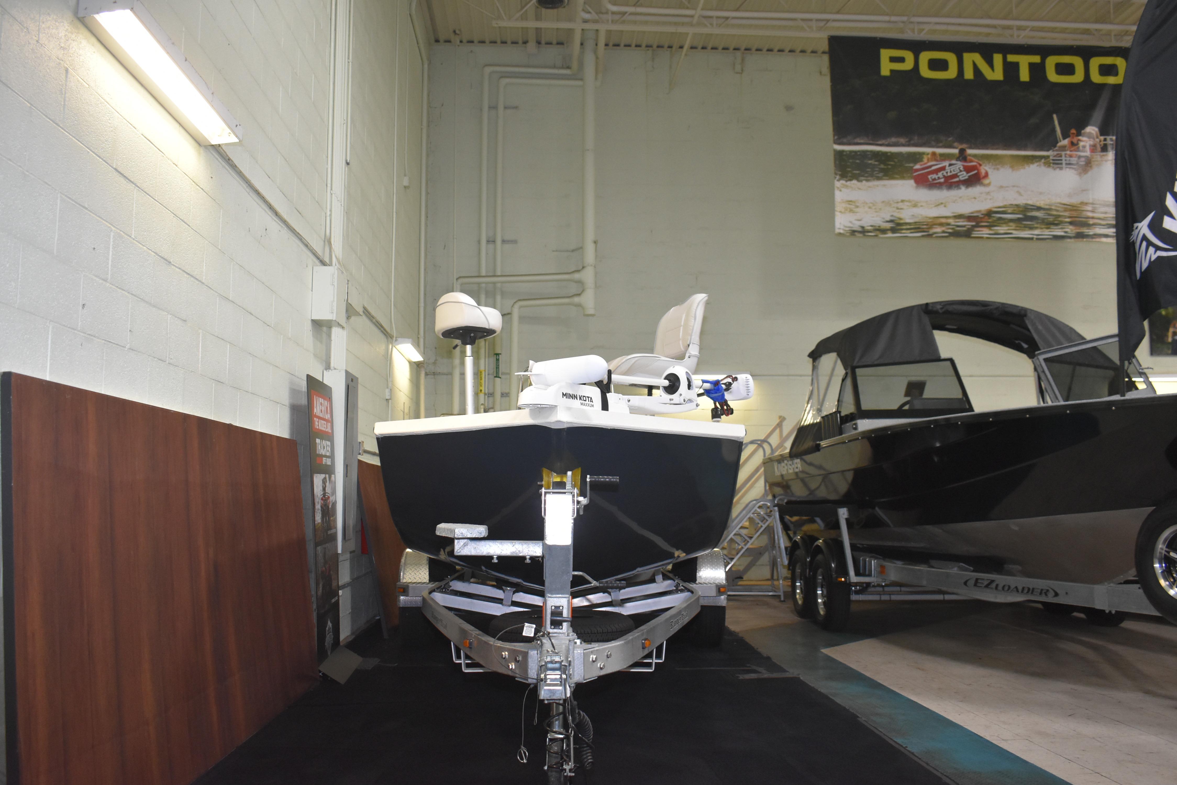 2024 Ranger RB200 boat displayed indoors alongside another boat, under a pontoon banner.