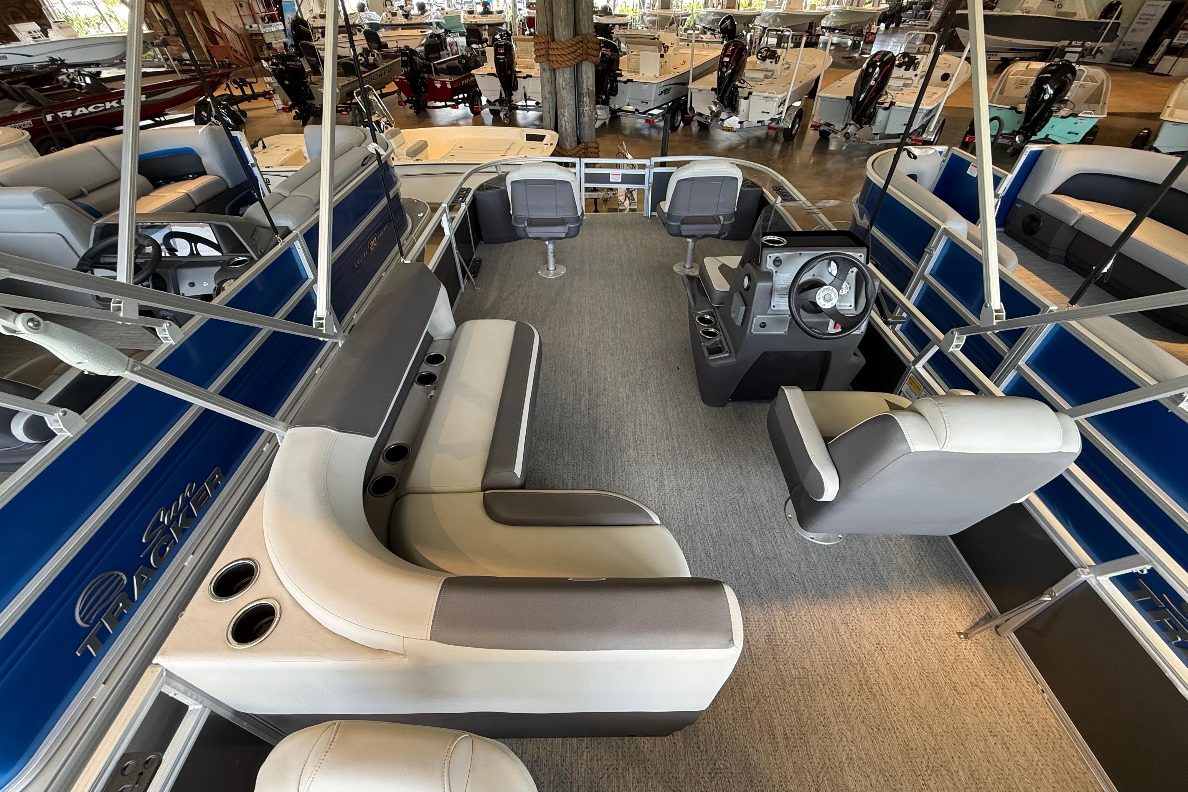 2026 Sun Tracker Bass Buggy 18 DLX pontoon boat interior with seating and steering console.