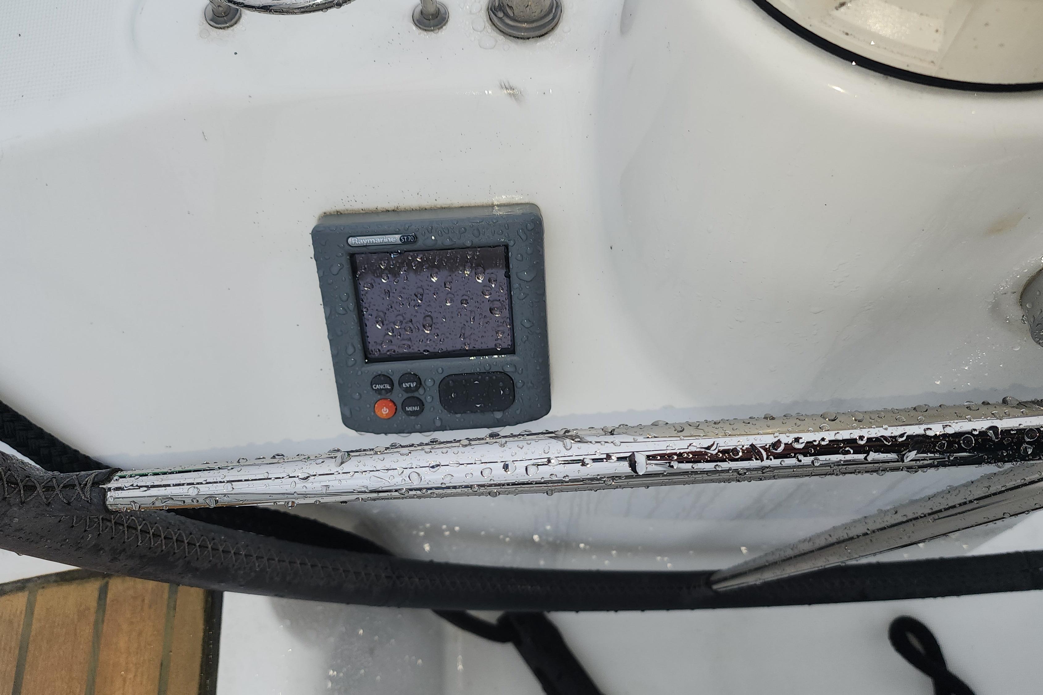 Close-up of a control panel on a 2012 Beneteau 40 yacht, with raindrops visible.