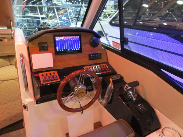 2025 Cutwater C-248 Coupe helm with modern controls and navigation display.