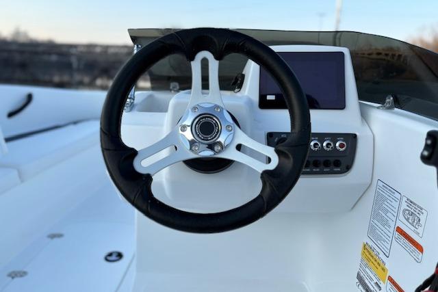 Steering wheel and dashboard of 2026 Tahoe T16 boat, featuring modern controls.
